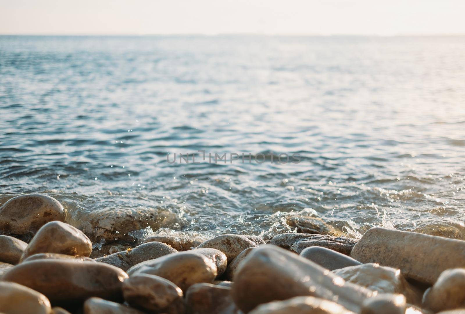 Pebble coast and calm sea.