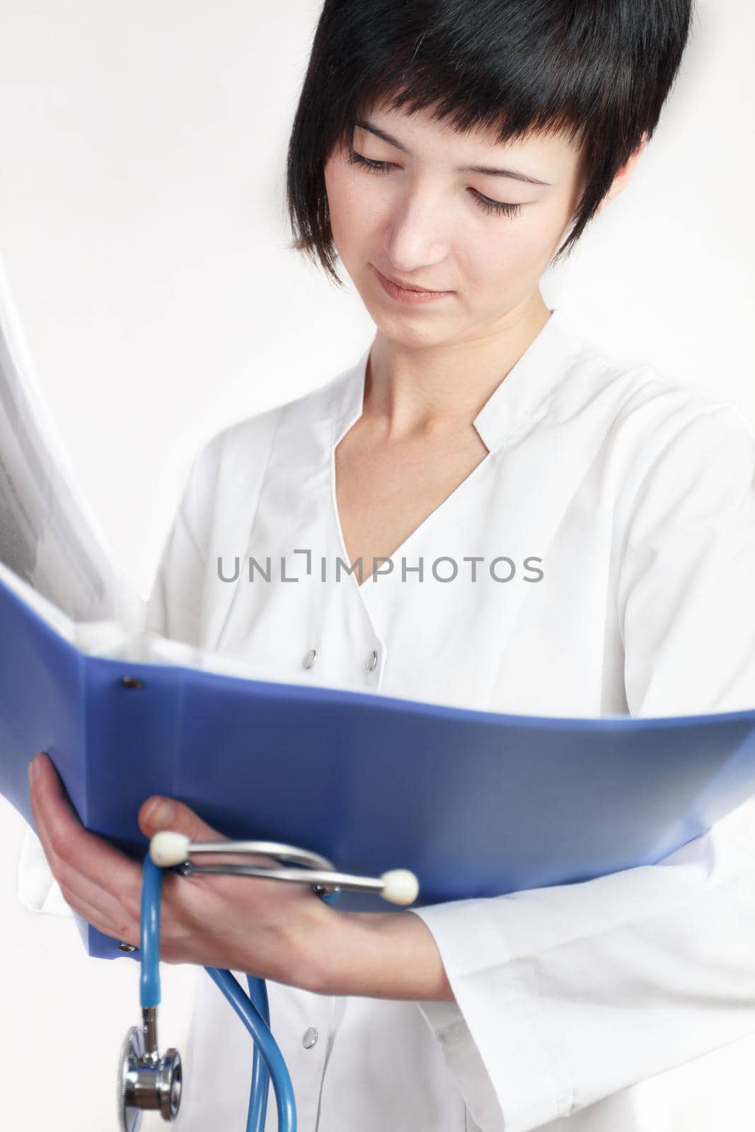 young woman doctor reads papers