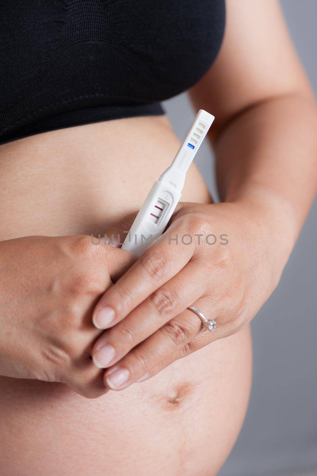 closeup pregnancy test in pregnant woman's hand