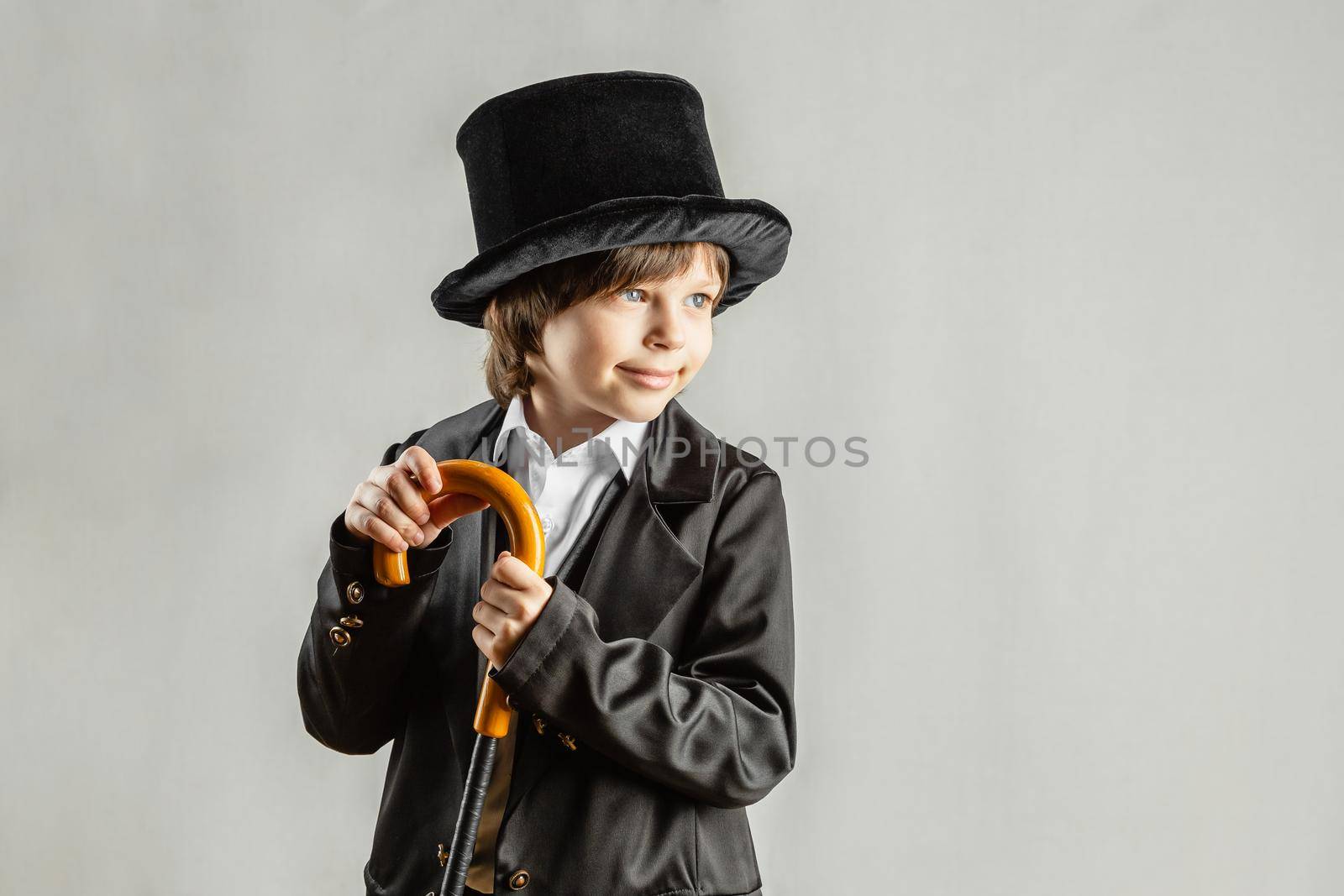 Young six year old boy wearing black suit by Syvanych