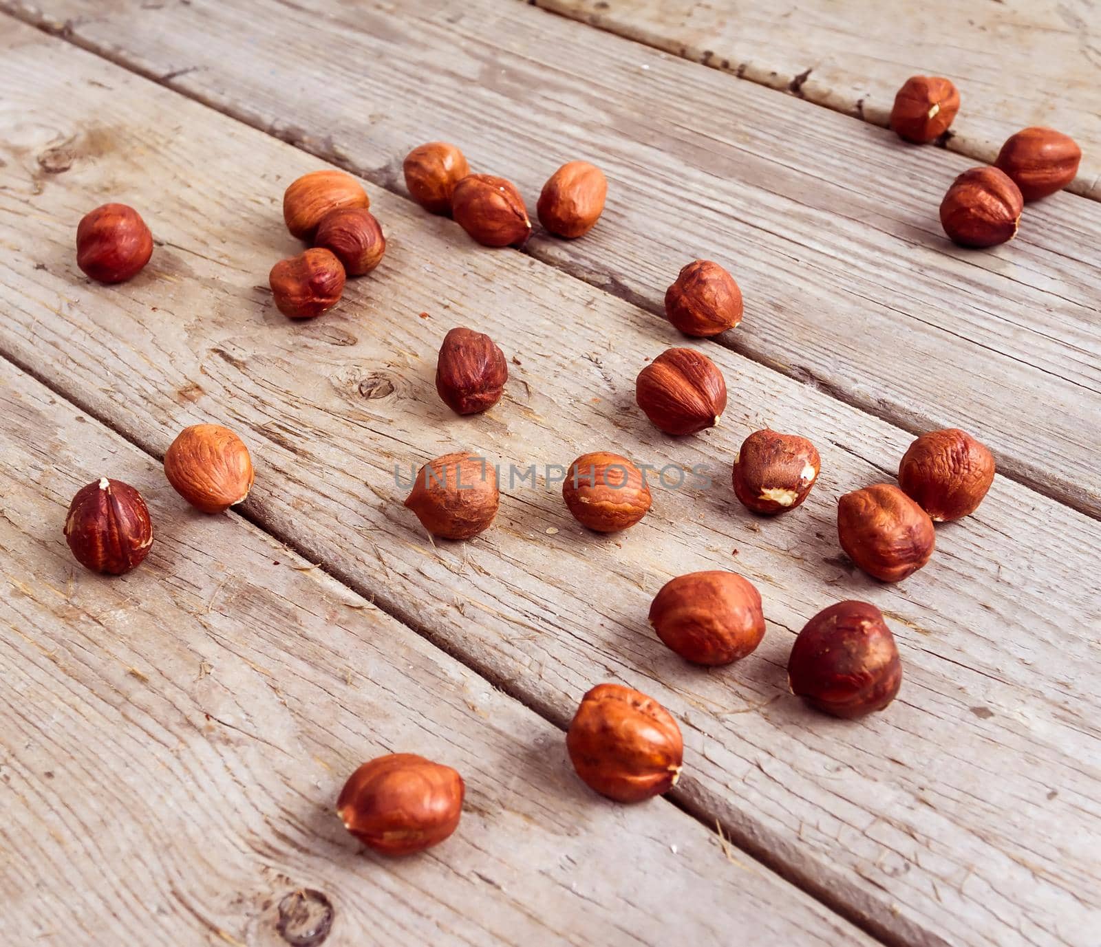 Many nuts scattered on wood background texture. Top view