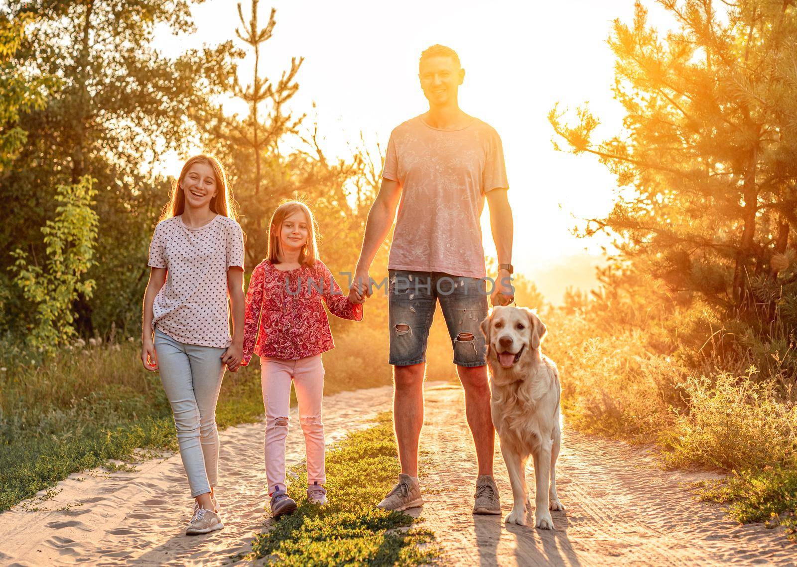 Father with daughters and retriever outdoors by tan4ikk1