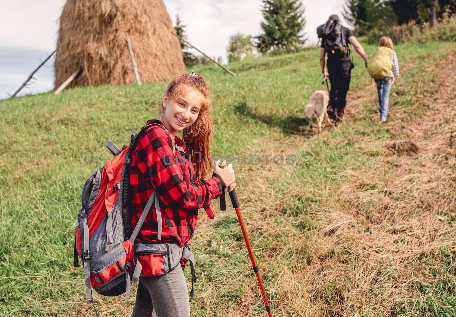 Teenage girl trekking in sunny mountains by tan4ikk1