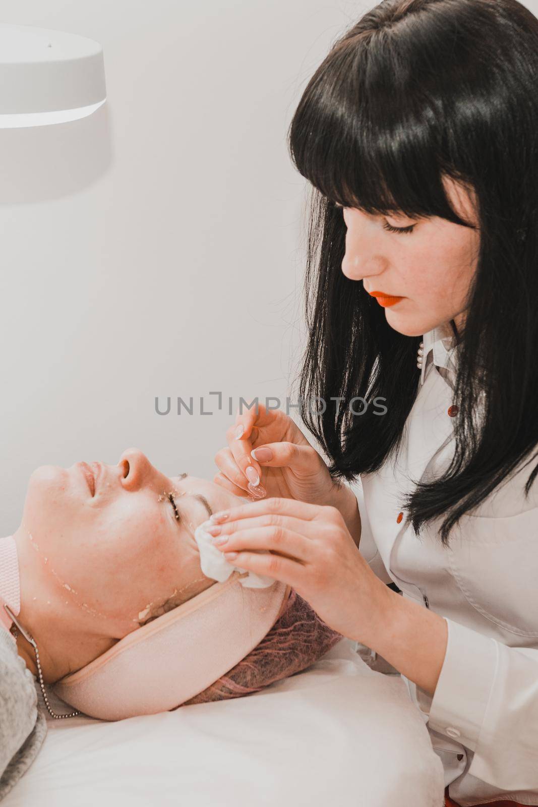 Facial massage at the beautician at the reception, visiting a beauty salon, a sense of relaxation. new