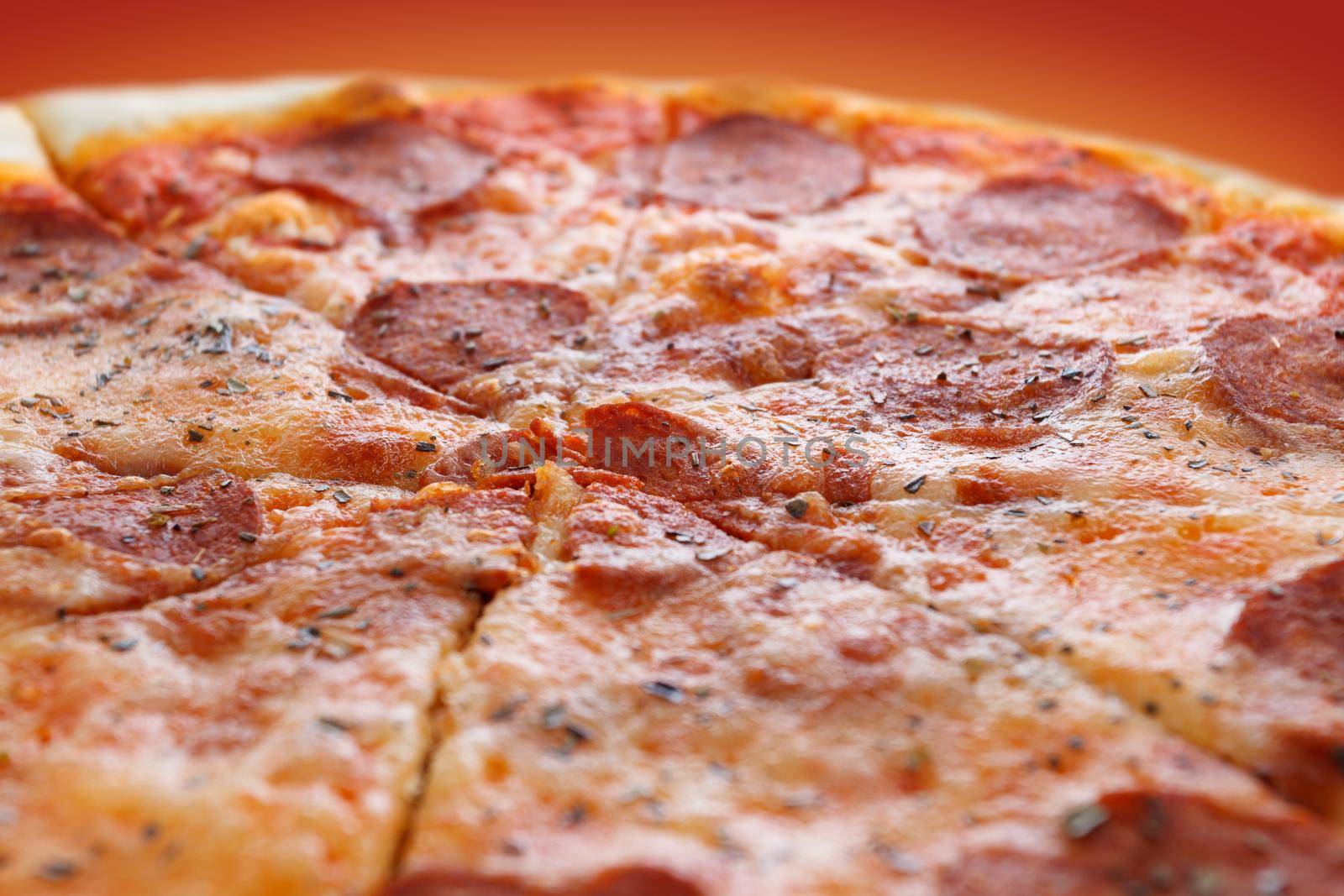 Pepperoni pizza on a red background