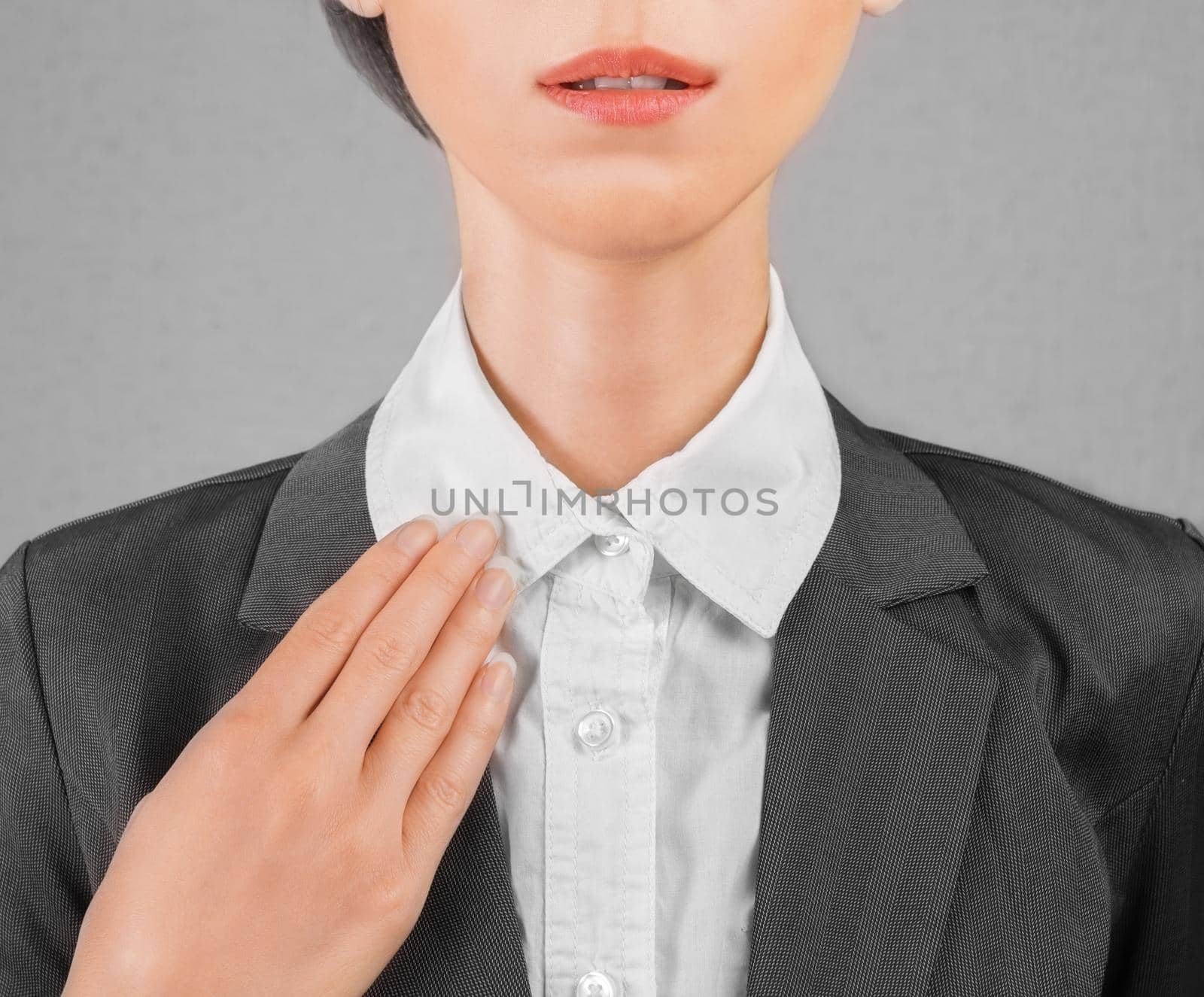 Young businesswoman straightens collar