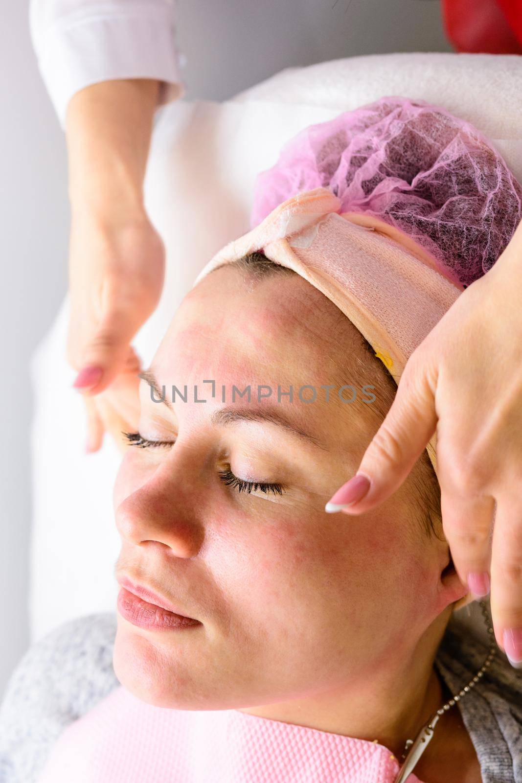 Happy and relaxed woman on cosmetology procedures, massage and applying face cream. new