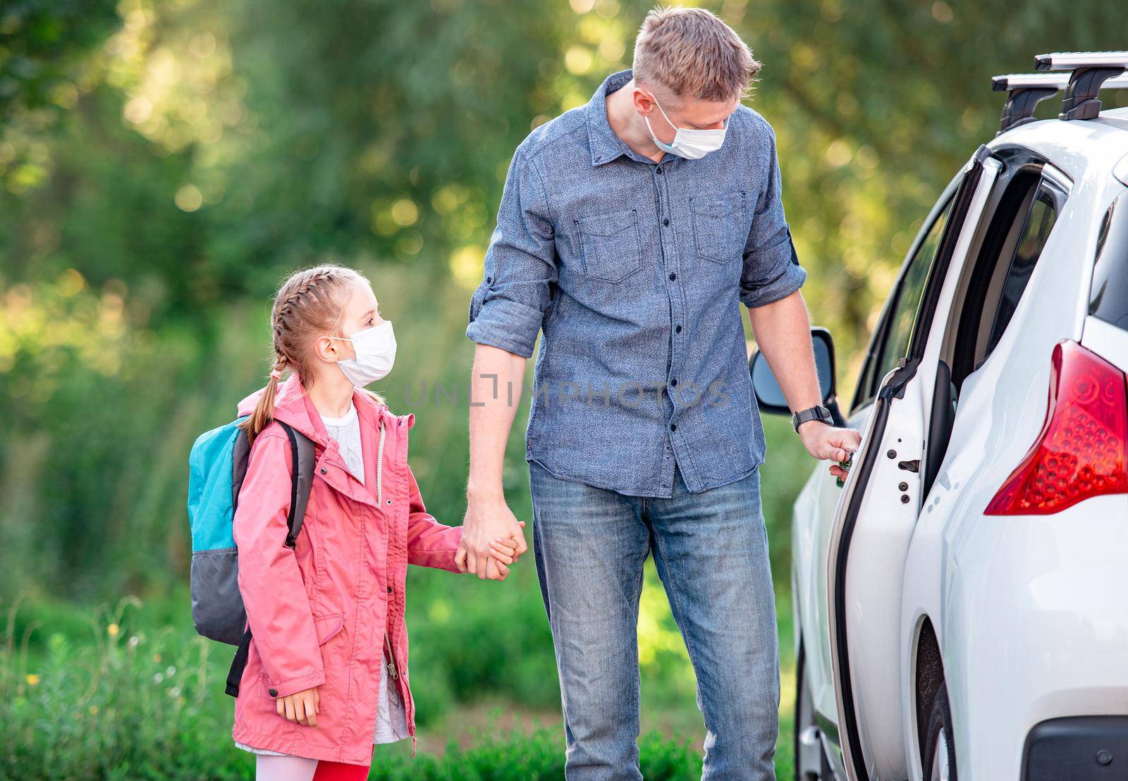 Father driving daughter to school during pandemic by tan4ikk1