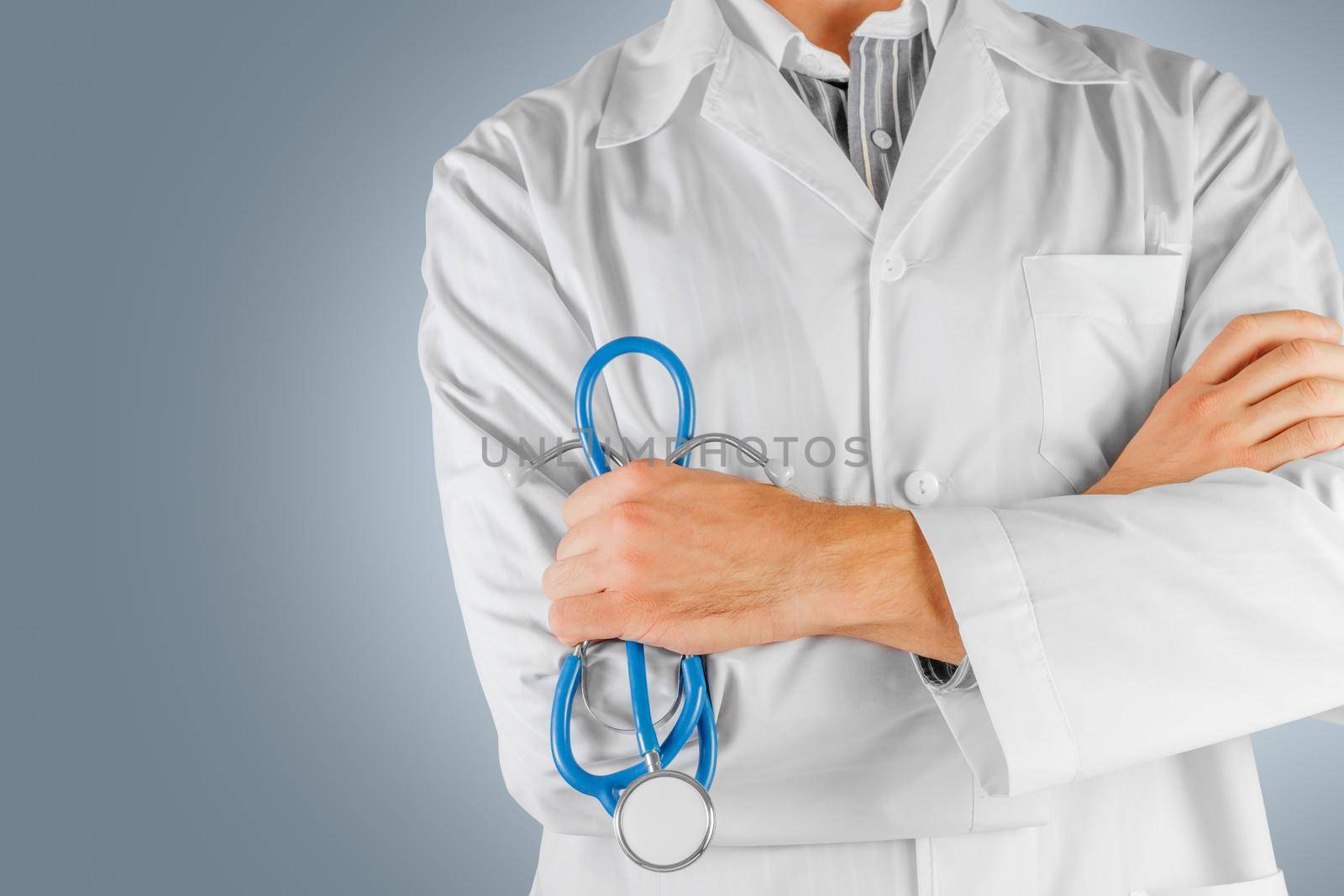 Confident male doctor with arms crossed. The face is not visible