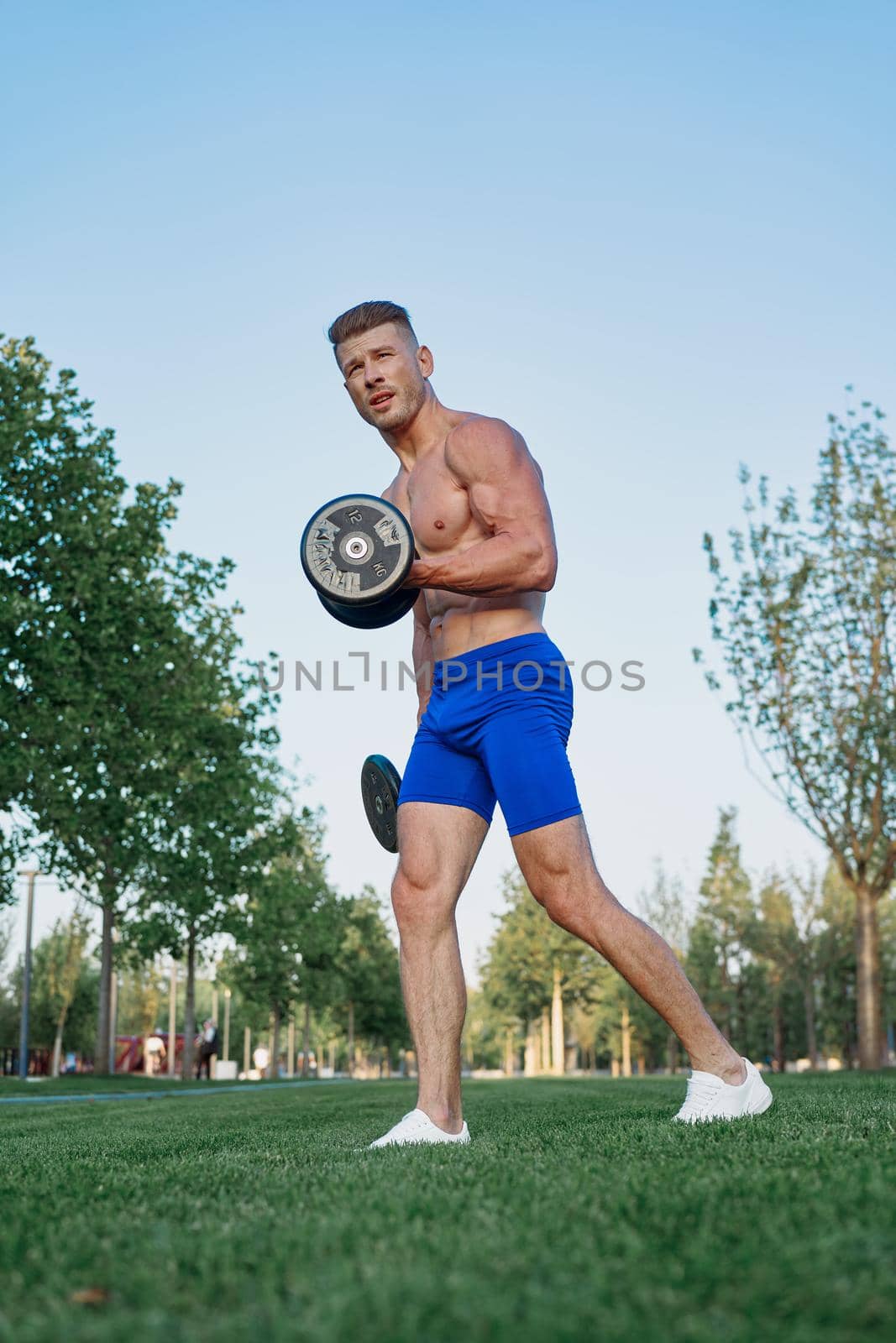 sporty man in park exercise crossfit workout. High quality photo