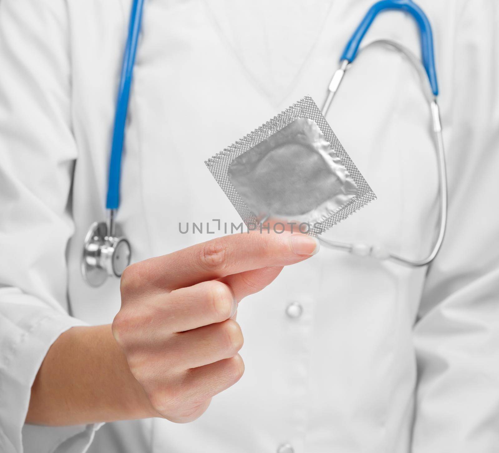 Doctor holding condom close-up. Concept safe Sex