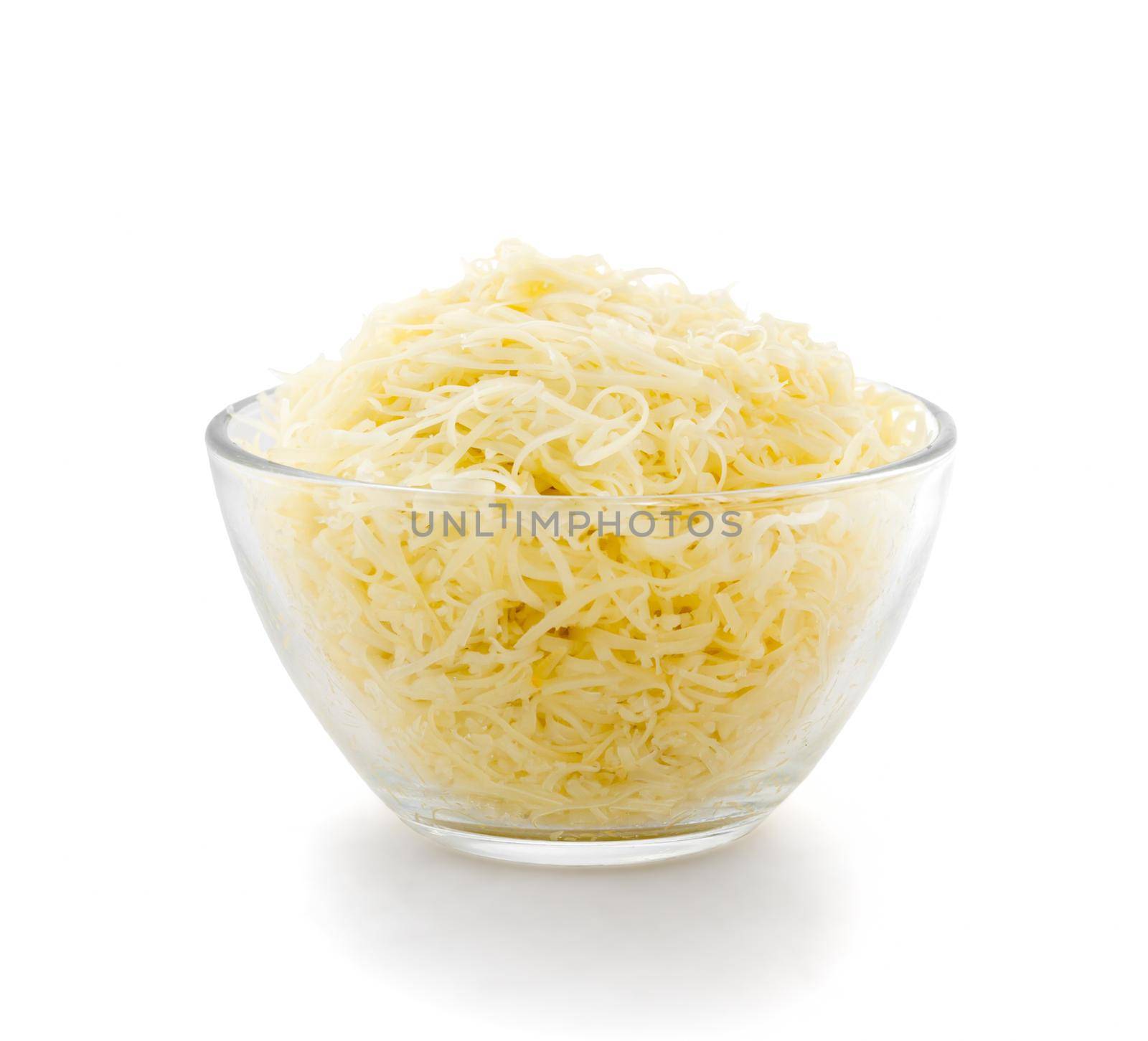 Grated cheese in a transparent plate on a white background. Side view.
