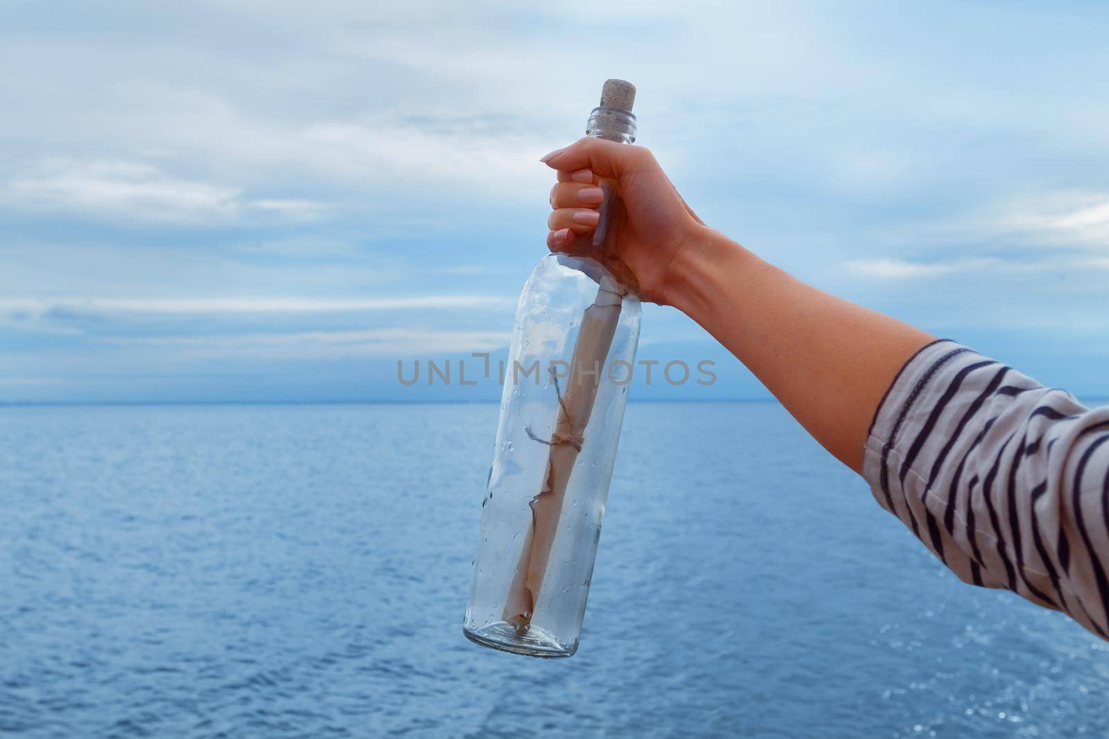 Bottle with a message in the hand