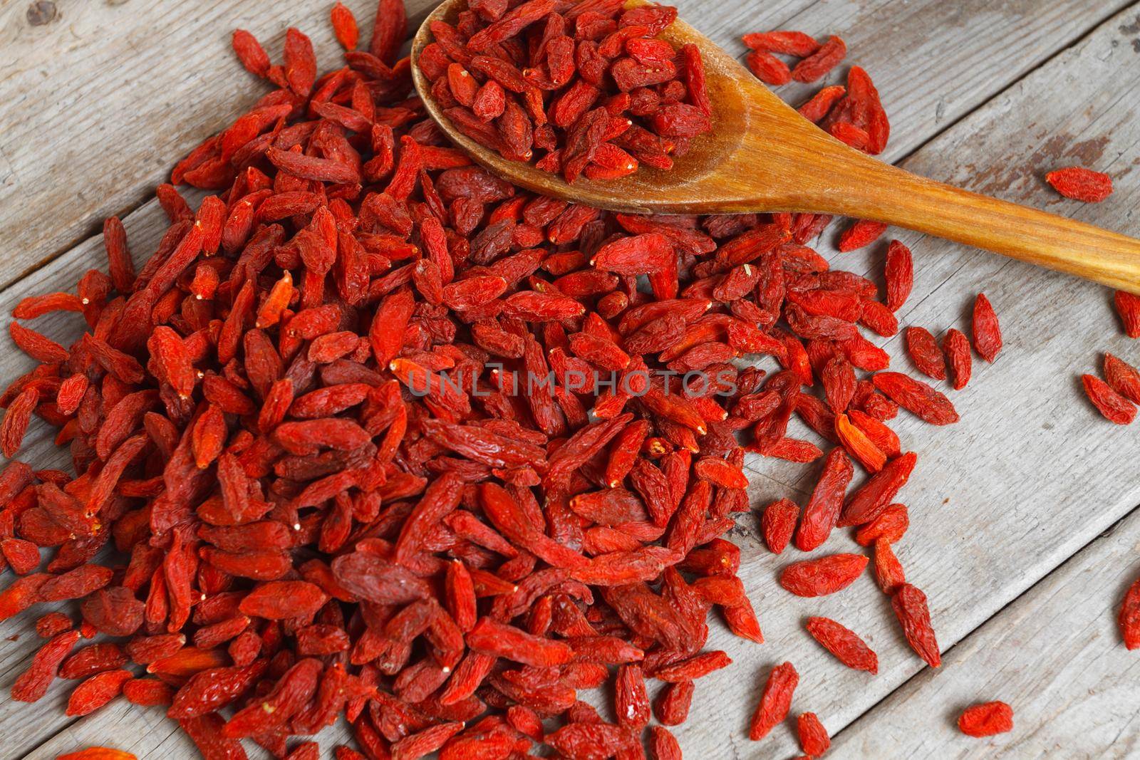 Heap of goji berries on a wooden background
