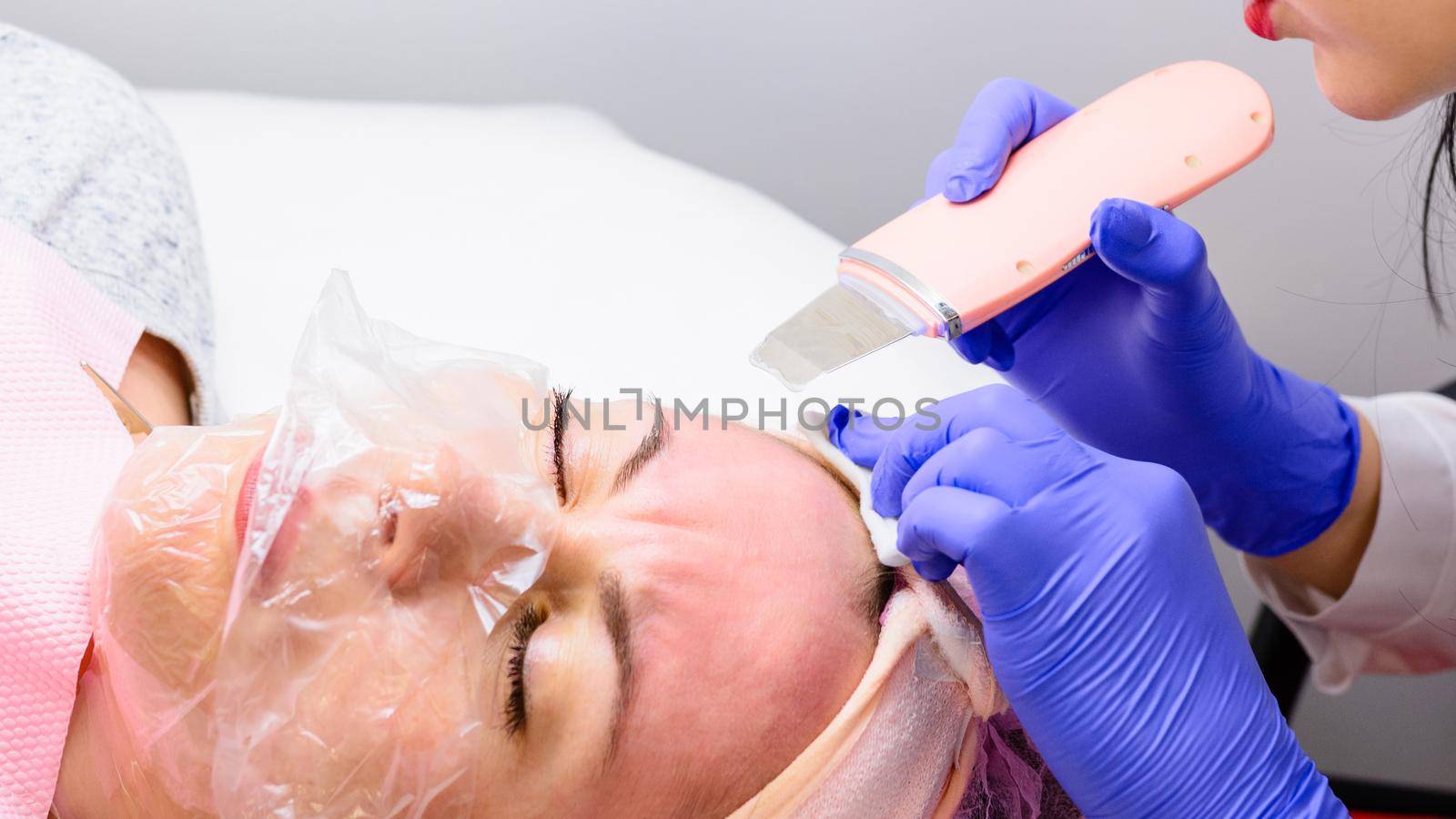 Ultrasonic facial cleansing, moisturizing, restoring and smoothing wrinkles. Facial cleansing with an ultrasonic scrubber. by Niko_Cingaryuk