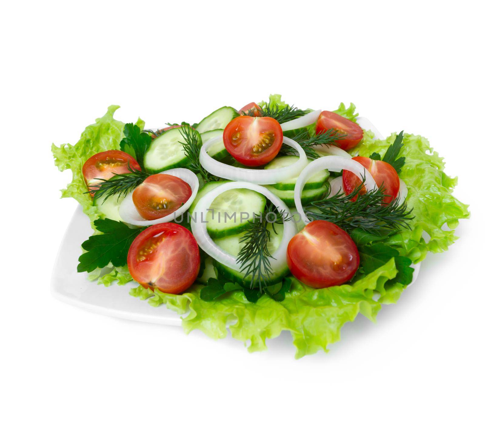 Salad of cucumbers, tomatoes and greens on a white background, side view