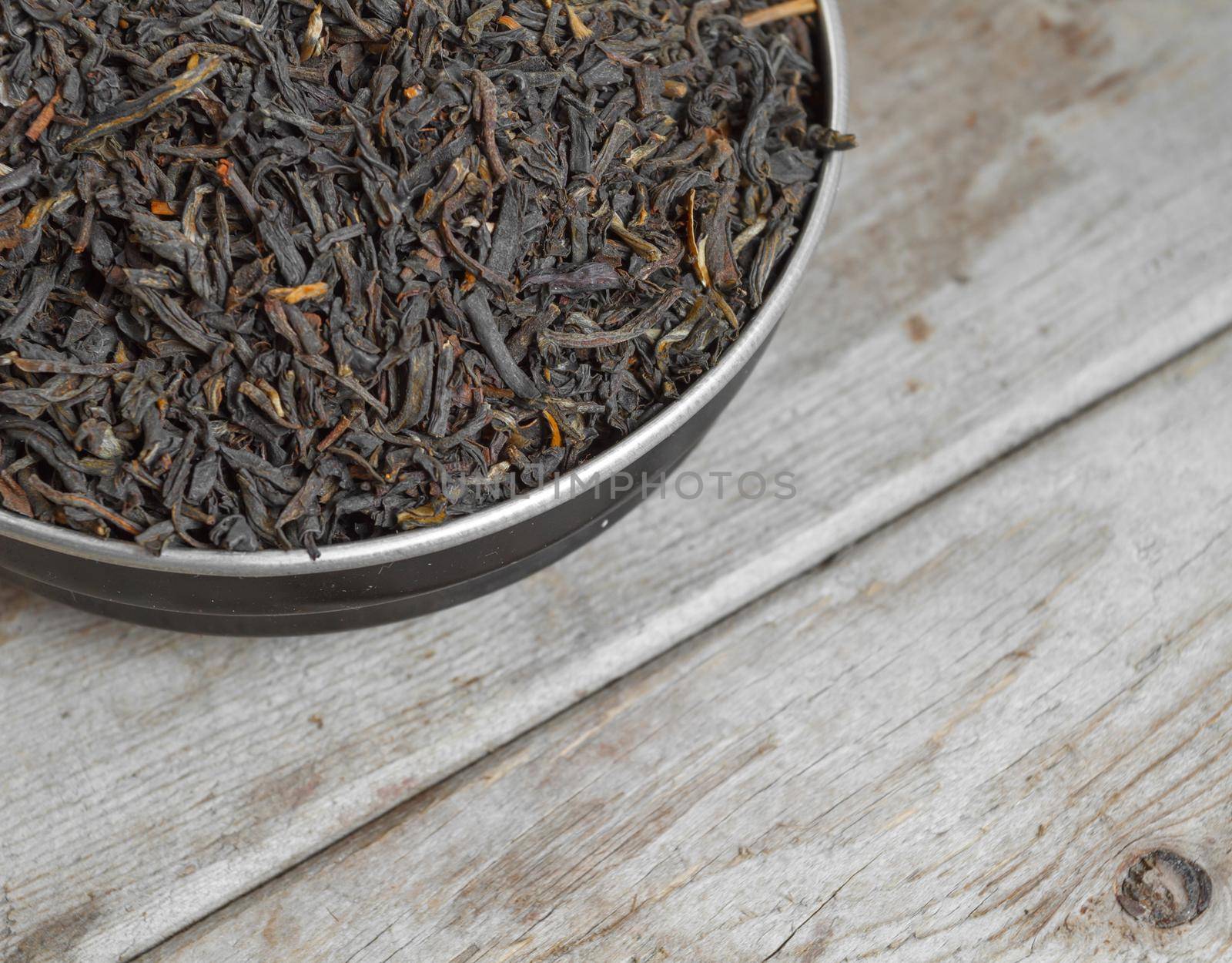 Leaf tea in a bowl close-up on wooden background