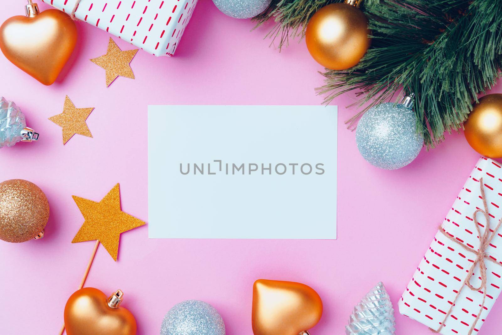 Christmas festive decorations with copy space on pink background, top view