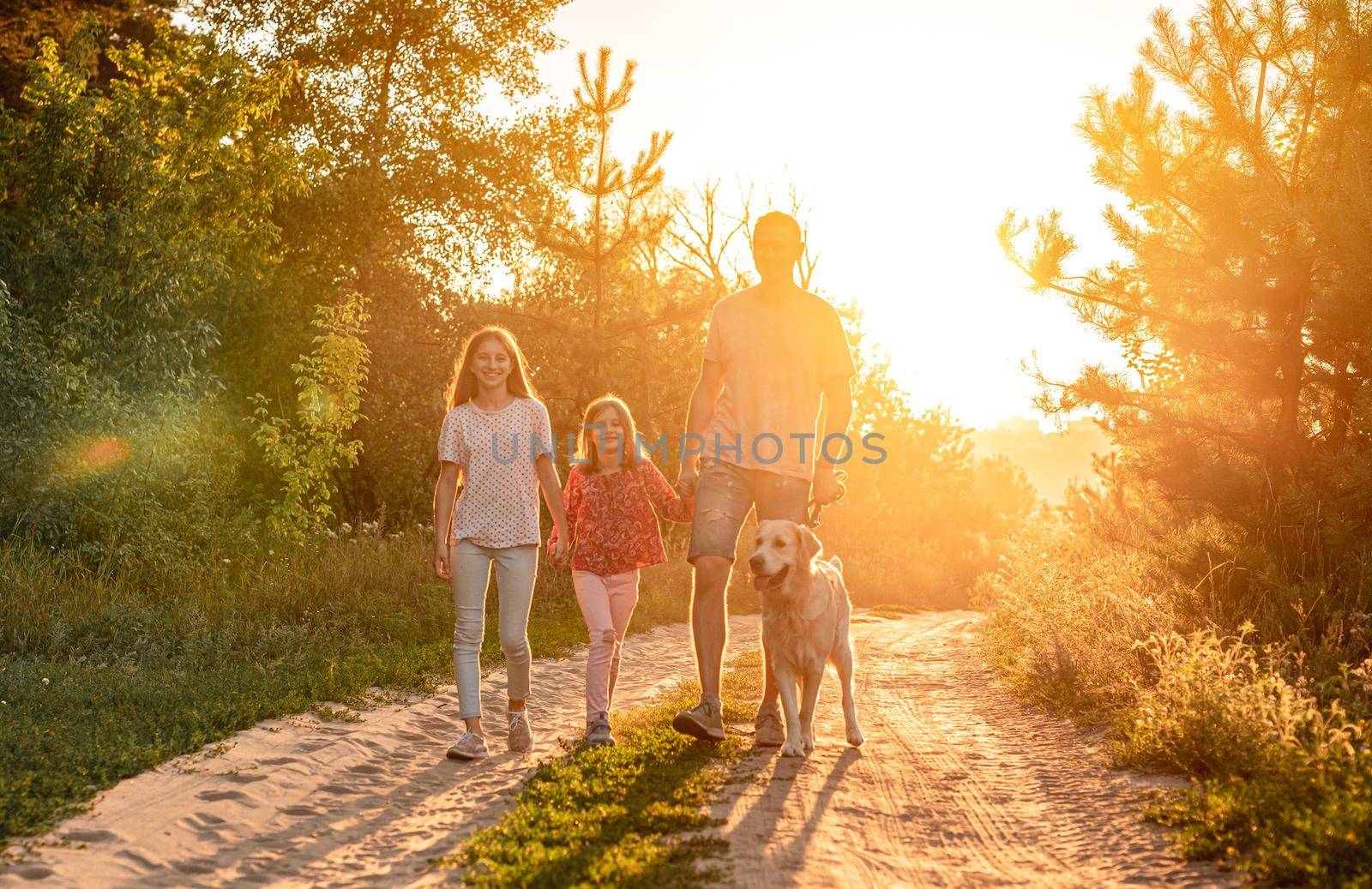 Father with daughters and retriever outdoors by tan4ikk1