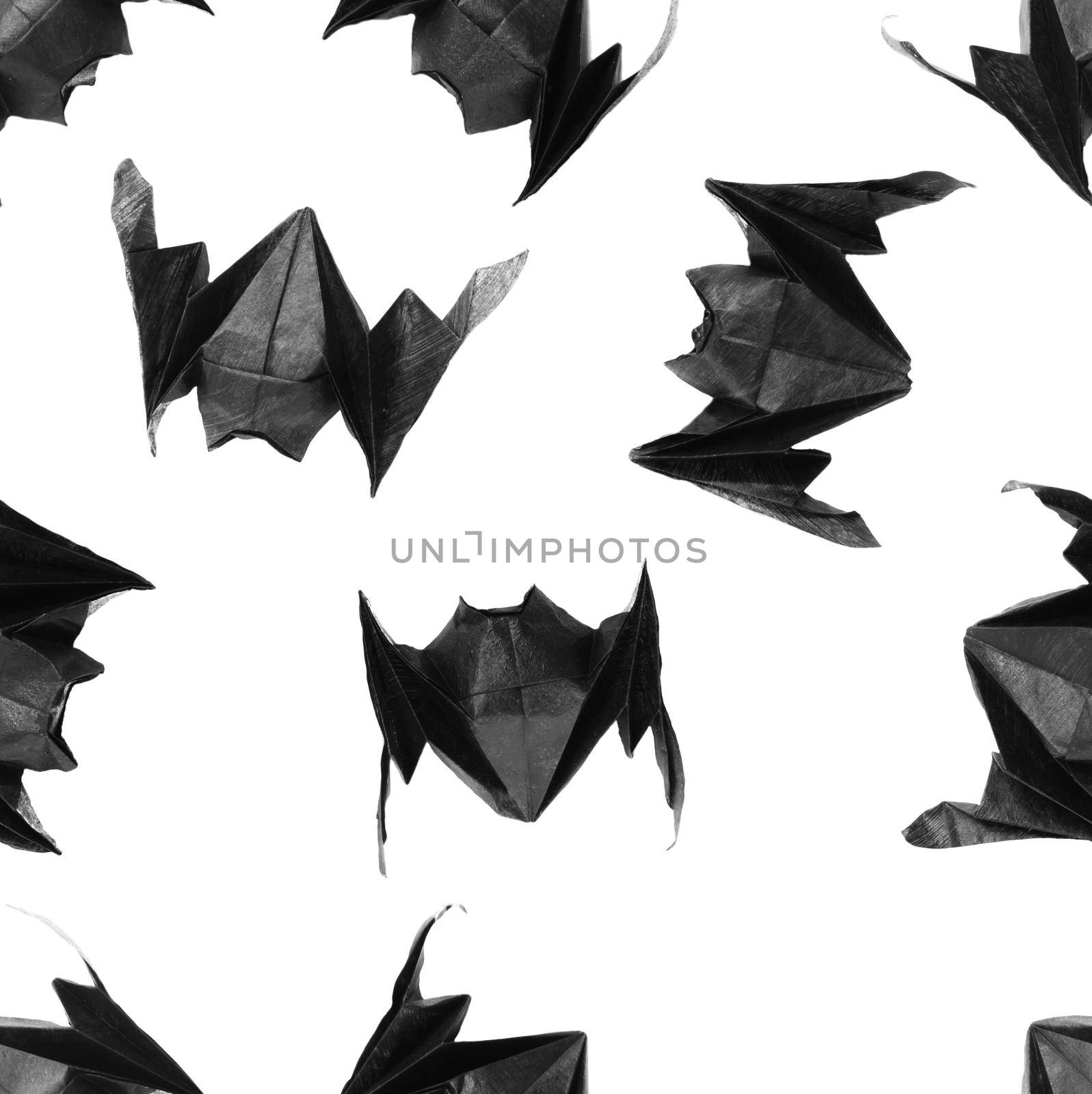 Lots of origami Halloween bats on a white background, texture, pattern