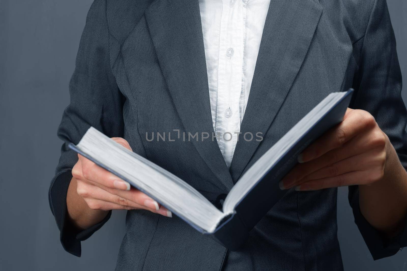 Unrecognizable woman holding an open book, close-up