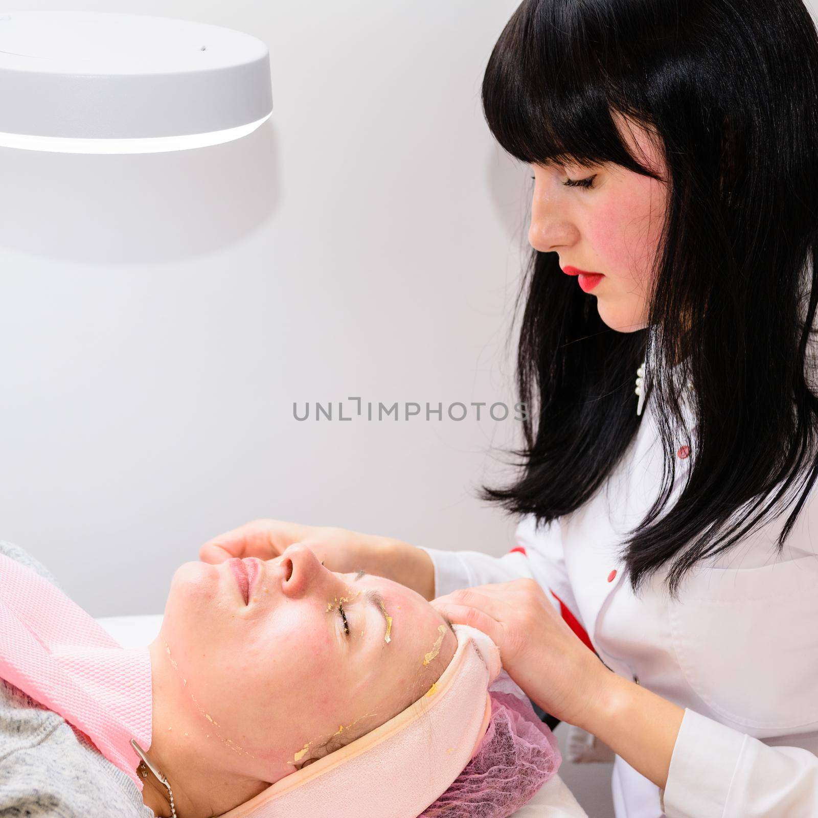 Facial massage at the beautician at the reception, visiting a beauty salon, a sense of relaxation. by Niko_Cingaryuk