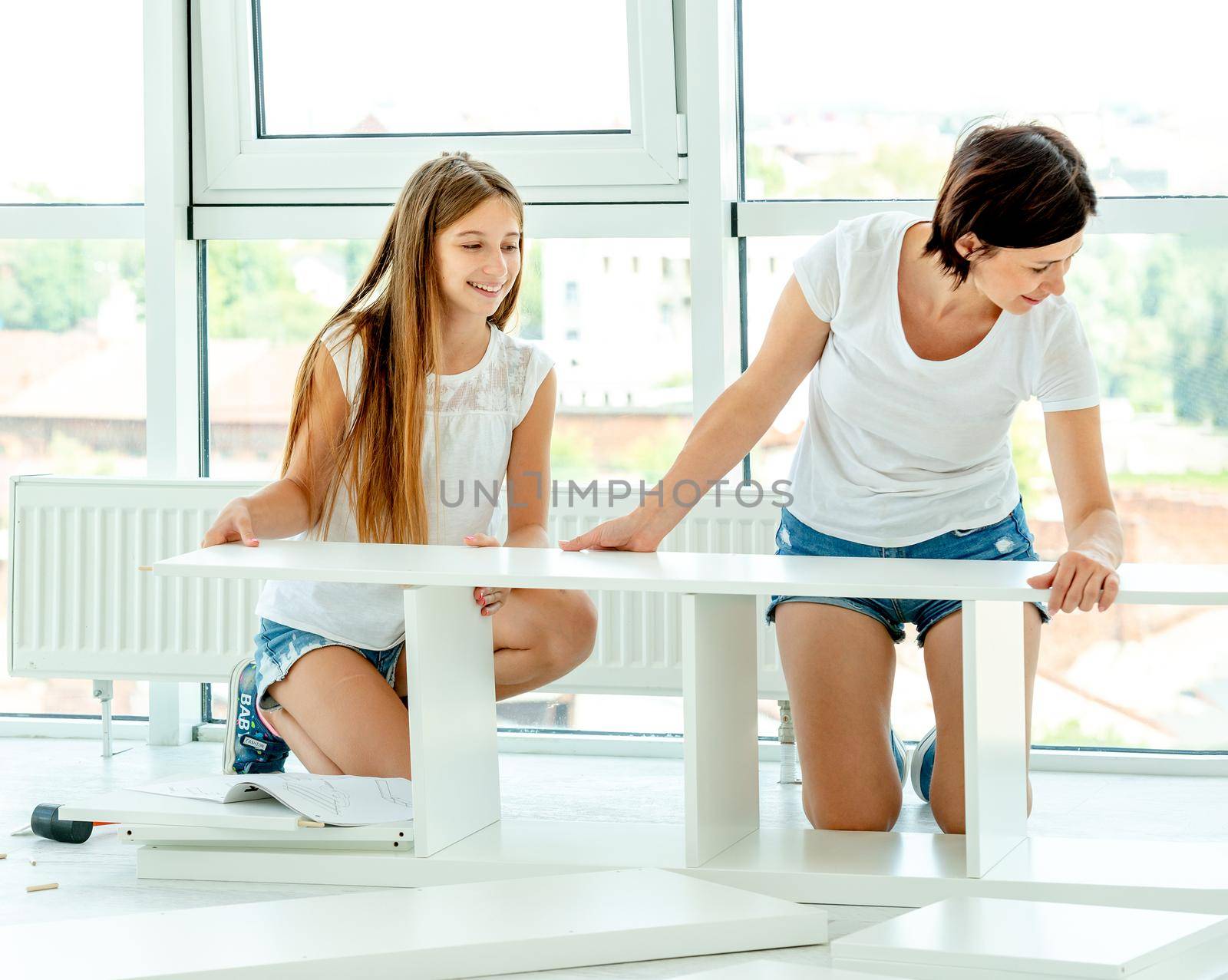Lovely mother and daughter working together on making new furniture