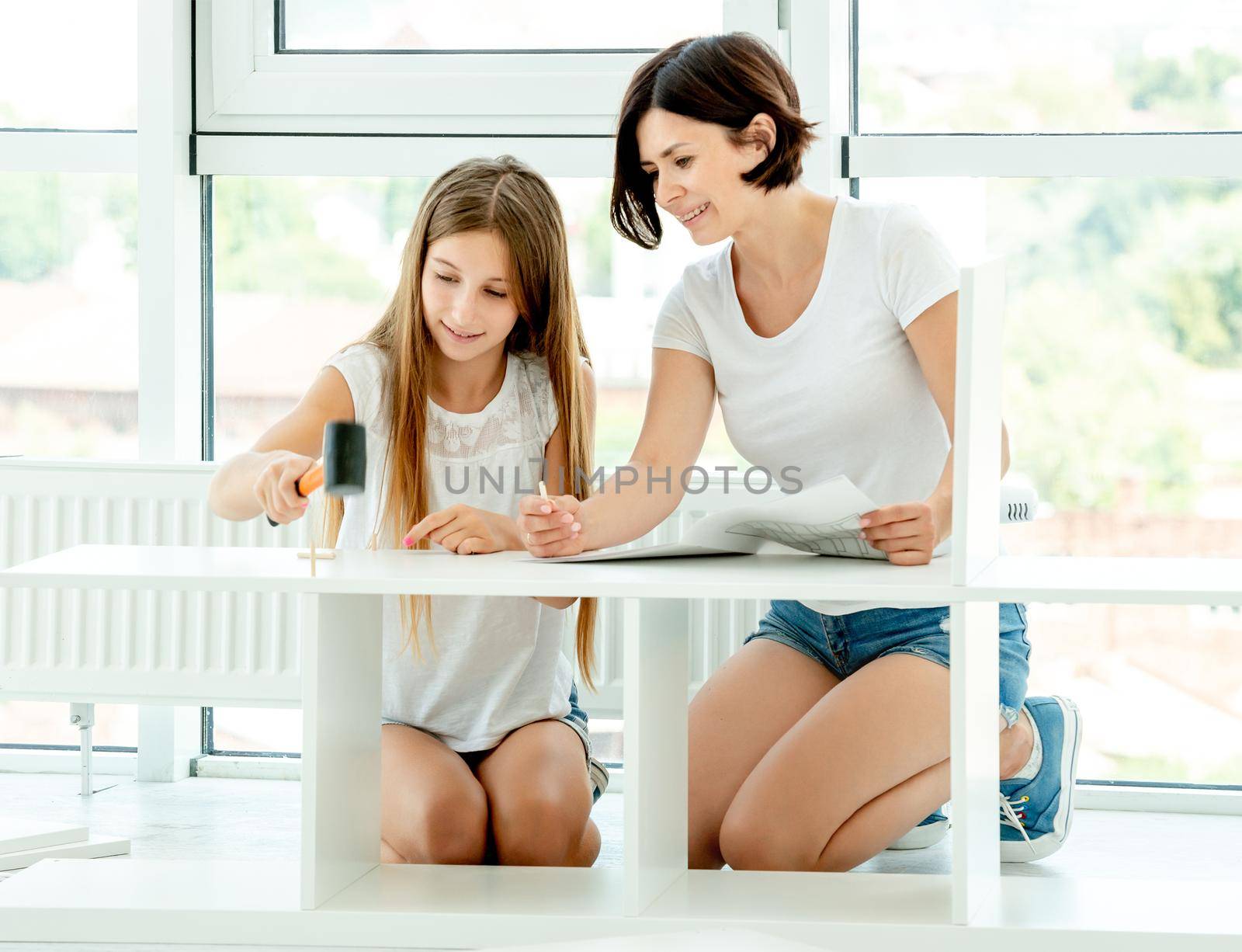 Lovely mother and daughter working together on making new furniture