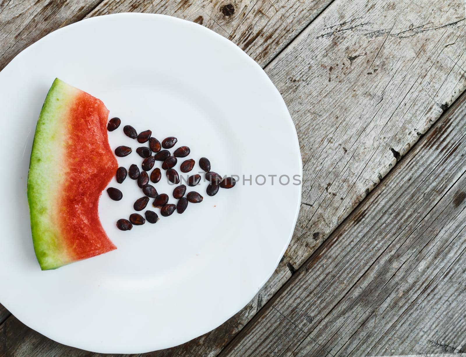 Eaten watermelon on a plate with pits