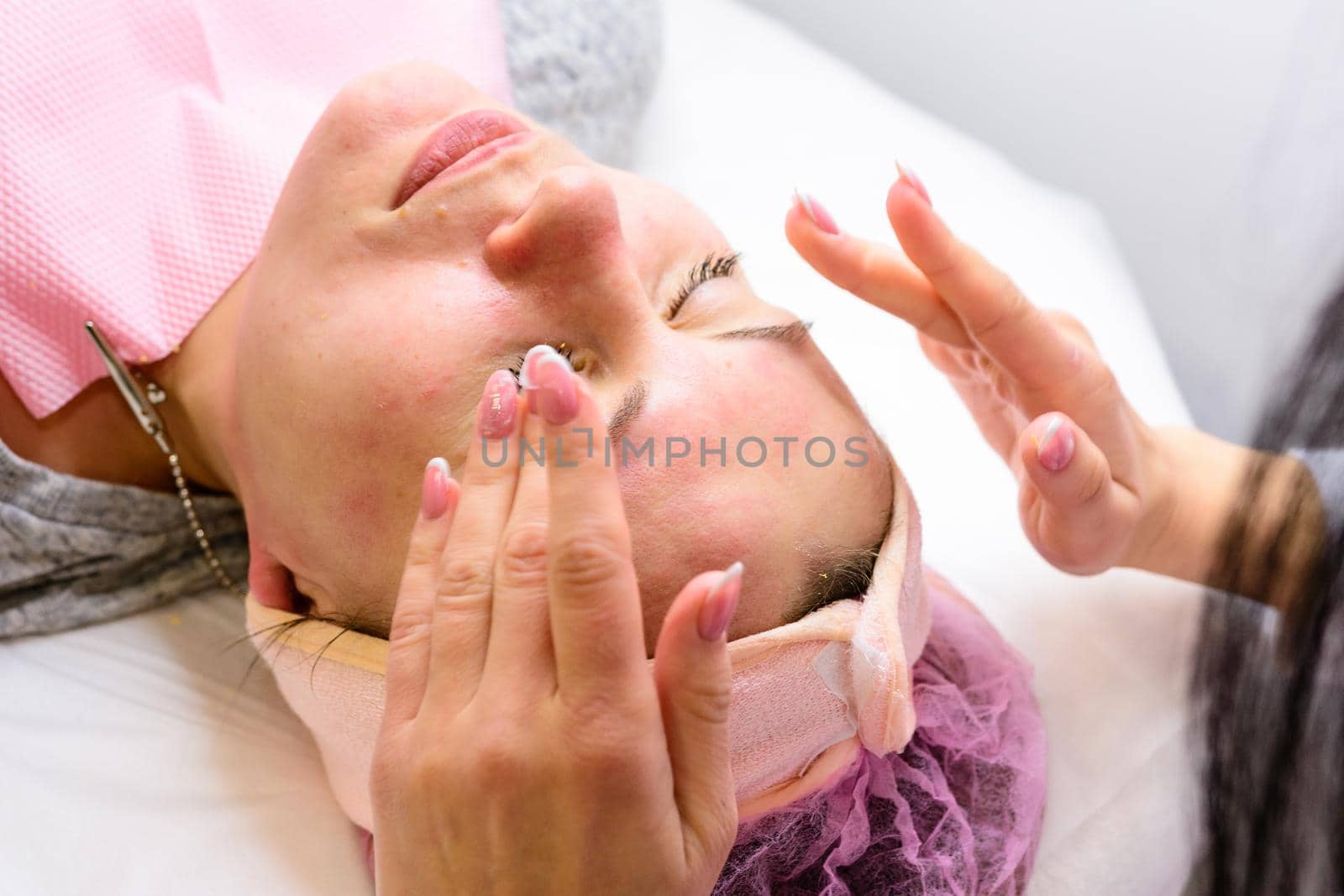 Happy and relaxed woman on cosmetology procedures, massage and applying face cream. new