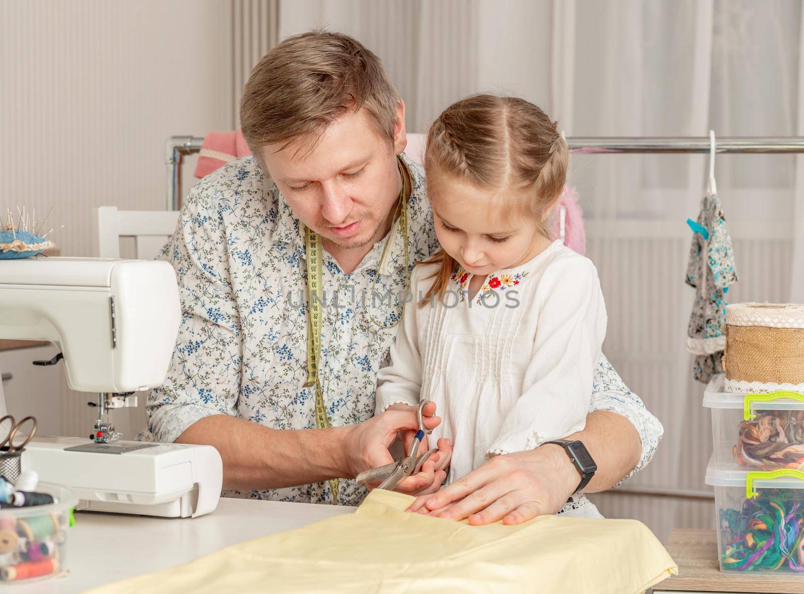 little girl and her dad in a sewing workshop by tan4ikk1