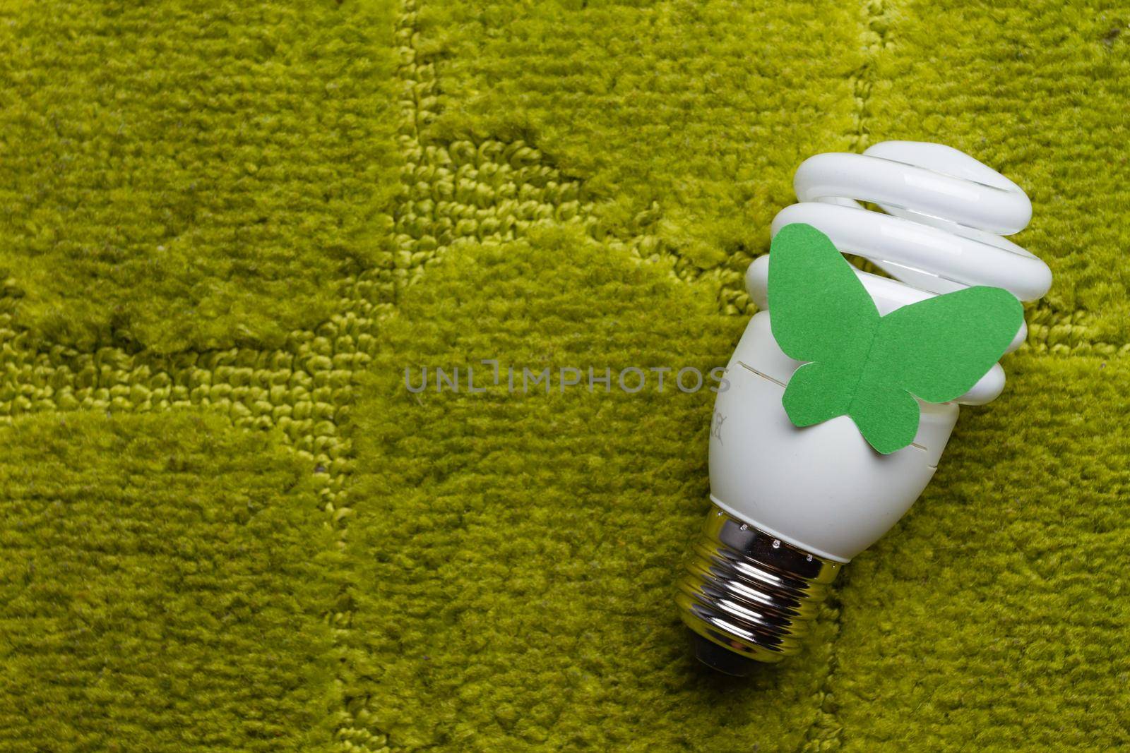 Energy saving bulb on a green background
