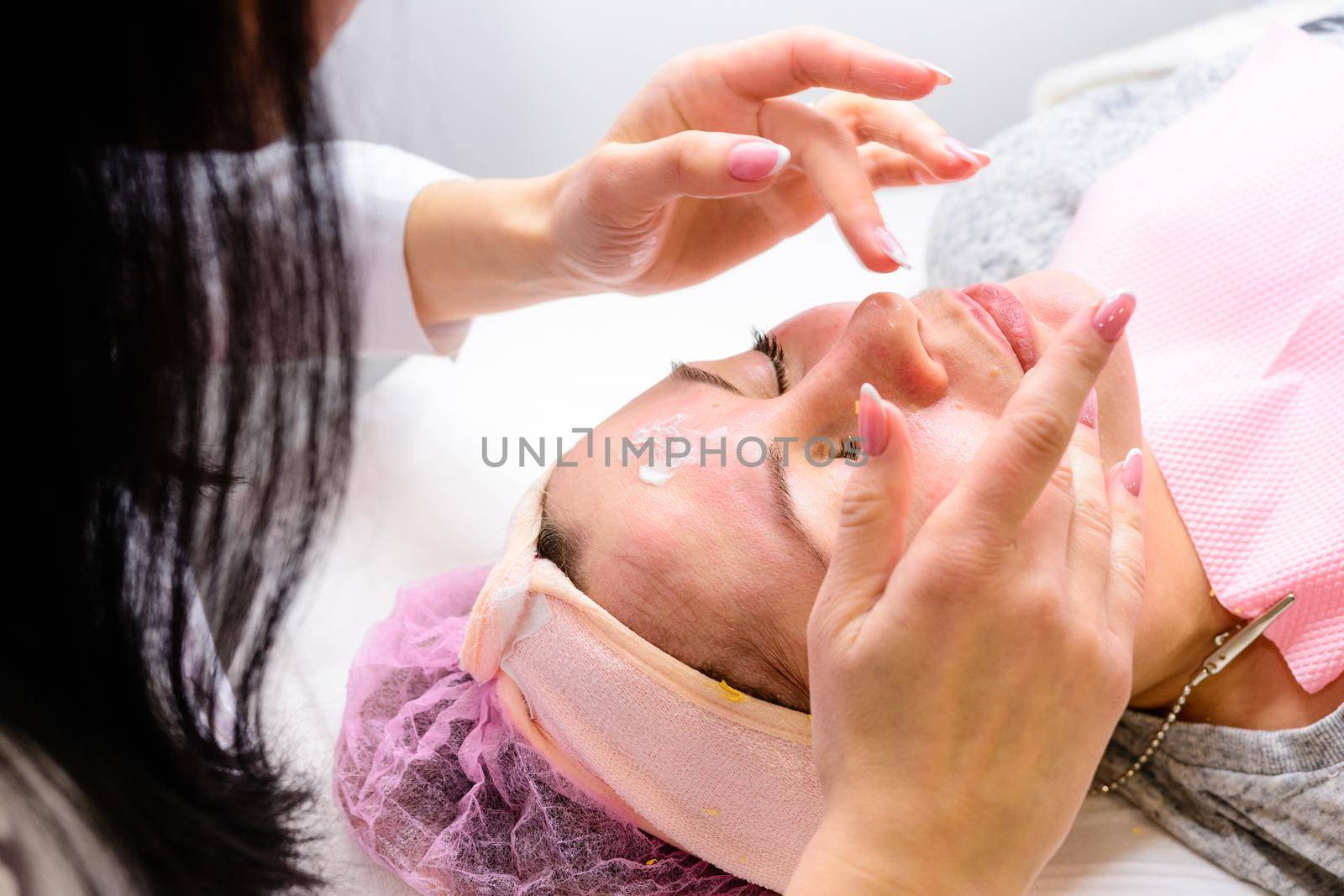 Facial massage at the beautician at the reception, visiting a beauty salon, a sense of relaxation. new