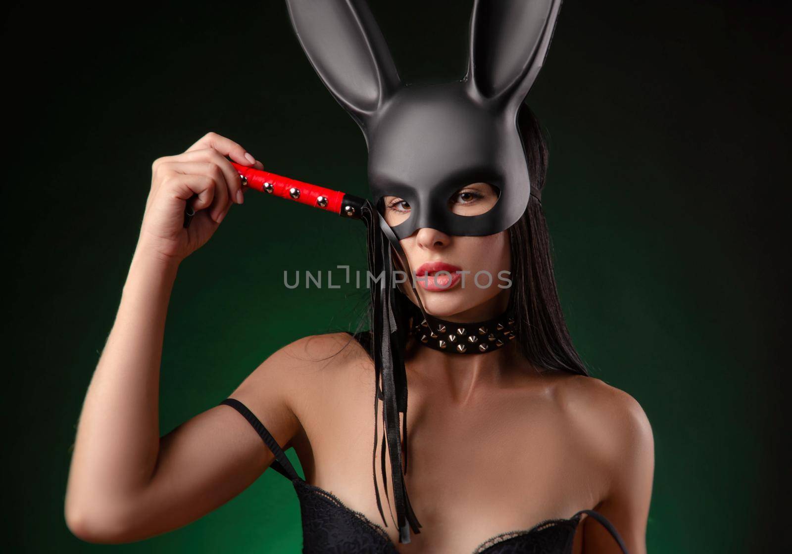 the sexy girl in underwear and rabbit mask with whip