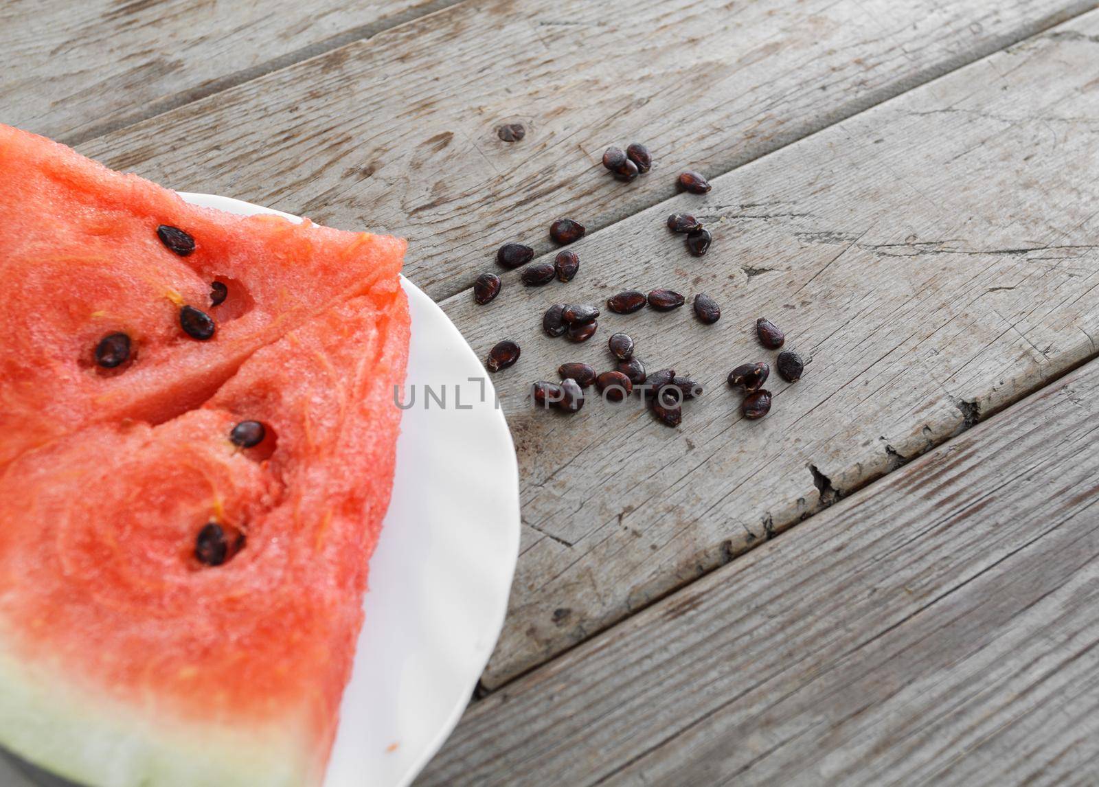 Slice of watermelon on a wooden table