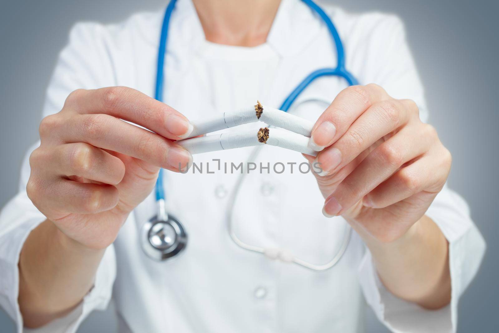 Unrecognizable doctor breaking a cigarette