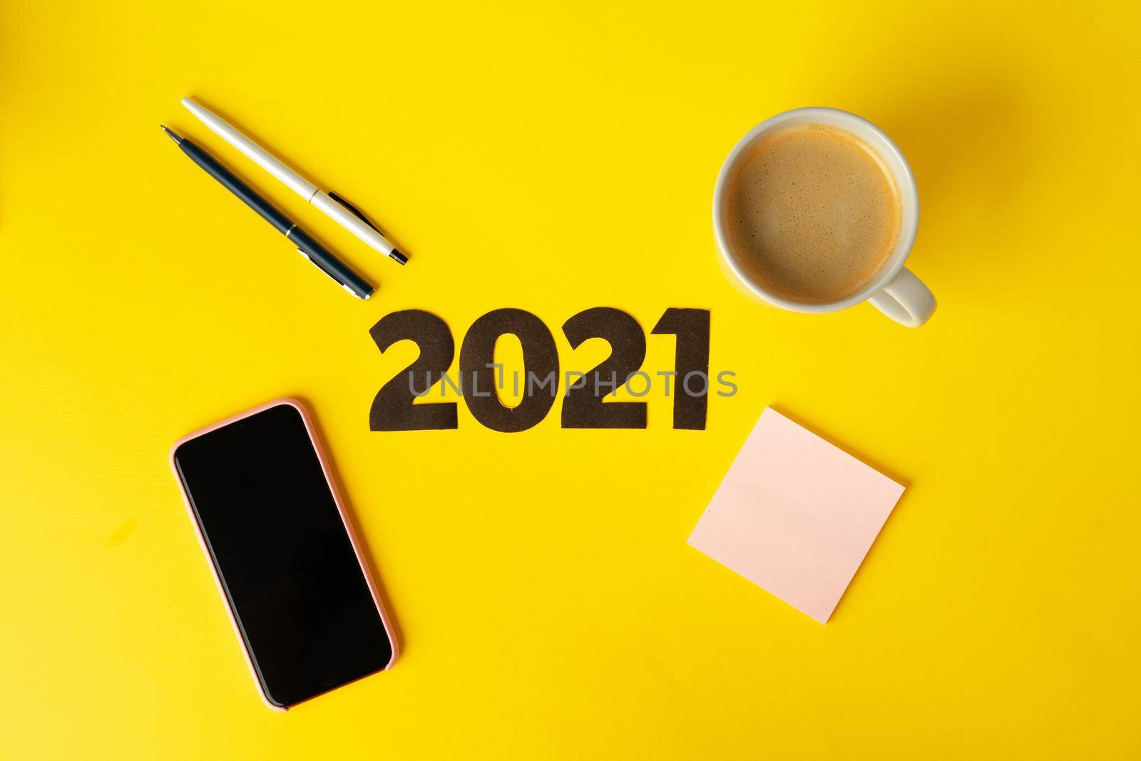 Office supplies and 2021 numbers, top view. New year business goals and plans concept