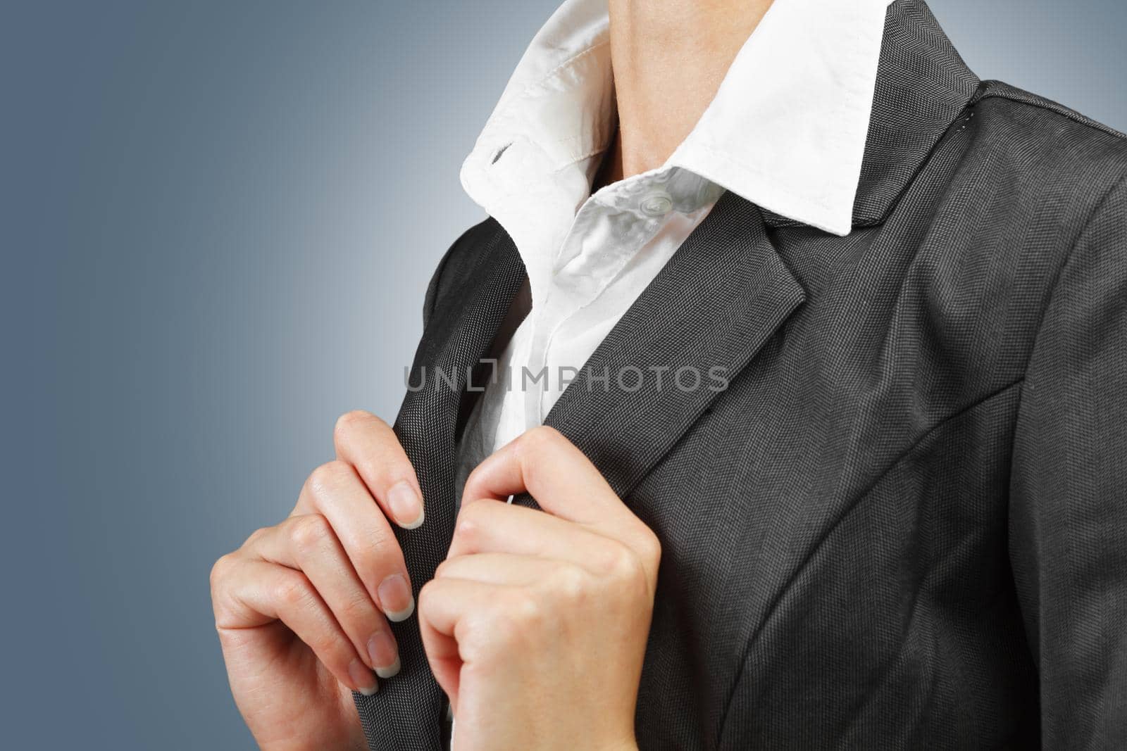 Young businesswoman straightens collar