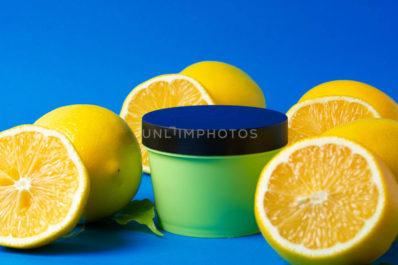 Bottle of skincare cosmetics with sliced lemons. High quality photo