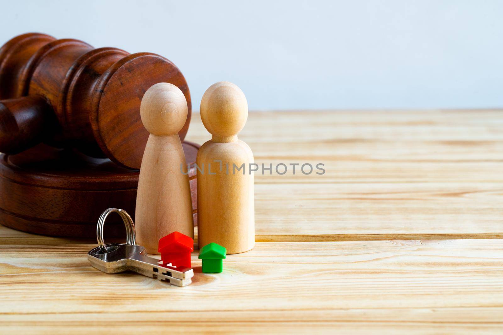 Divorse property division concept. Wooden family with house and judge gavel close up