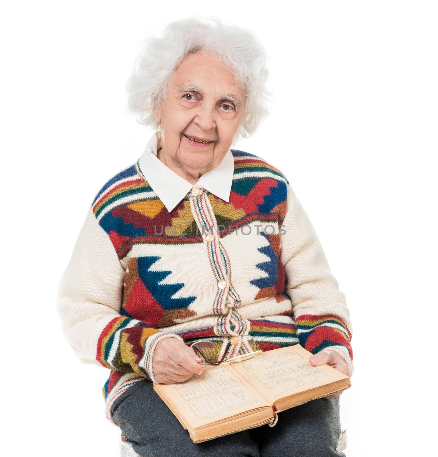 elderly woman flipping an old book by tan4ikk1