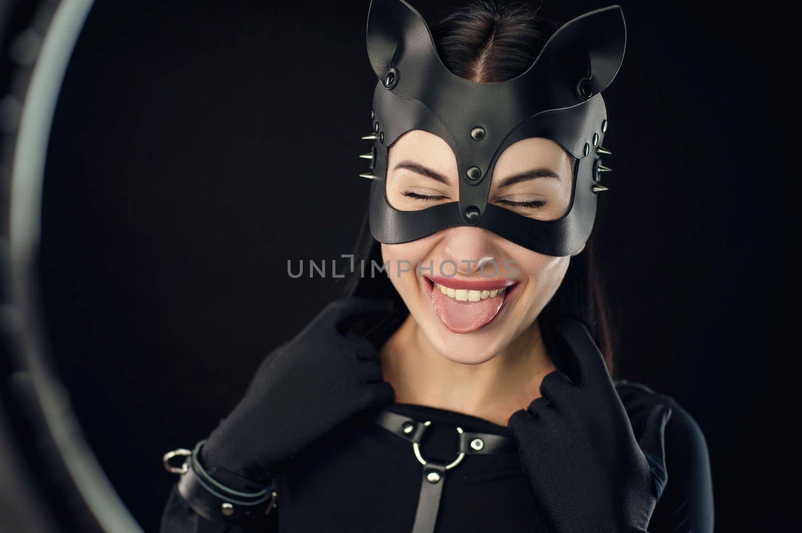 a woman in black belt and cat mask emotional portrait by Rotozey