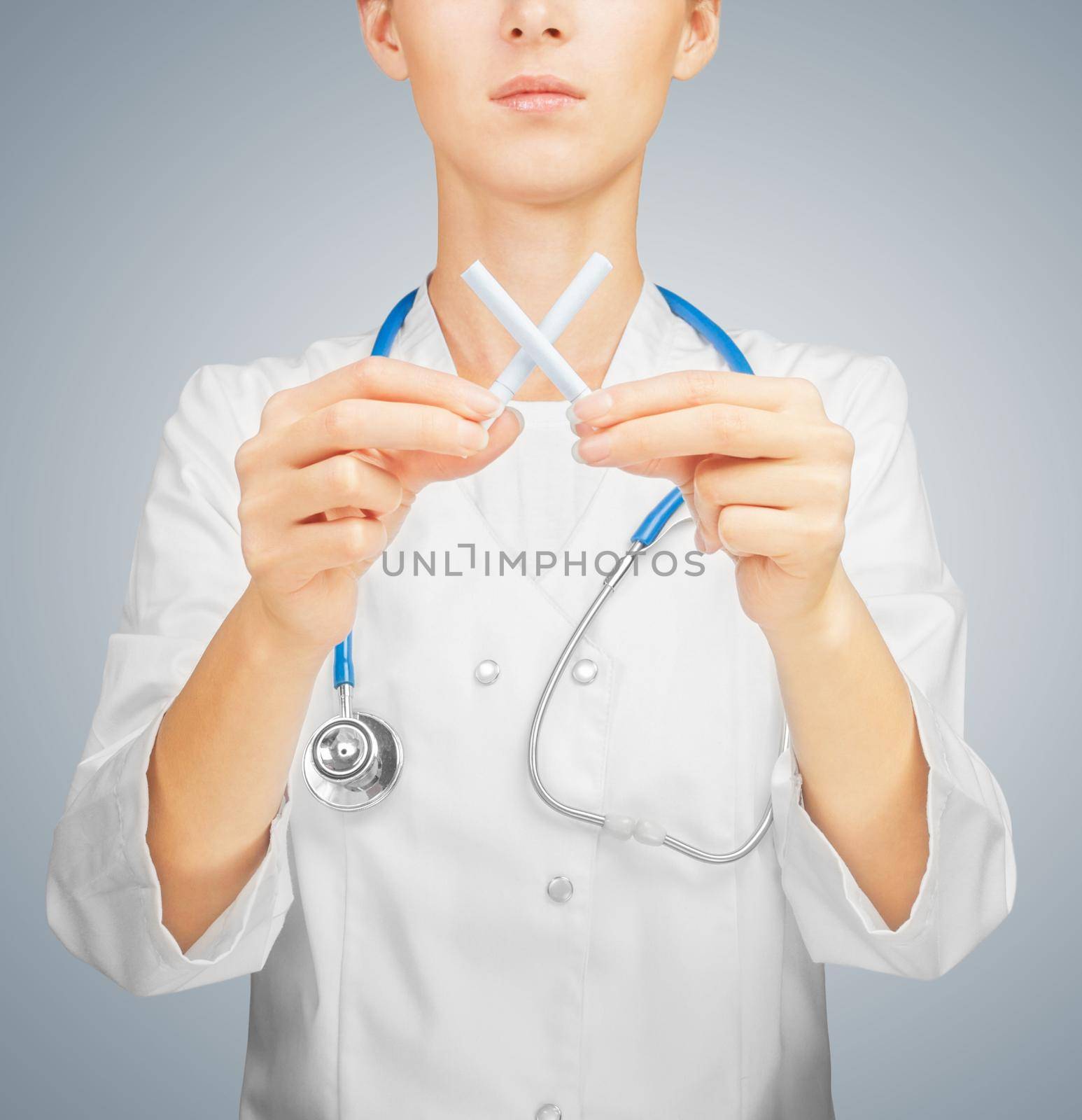 Doctor holds crossed cigarettes, concept of healthy life