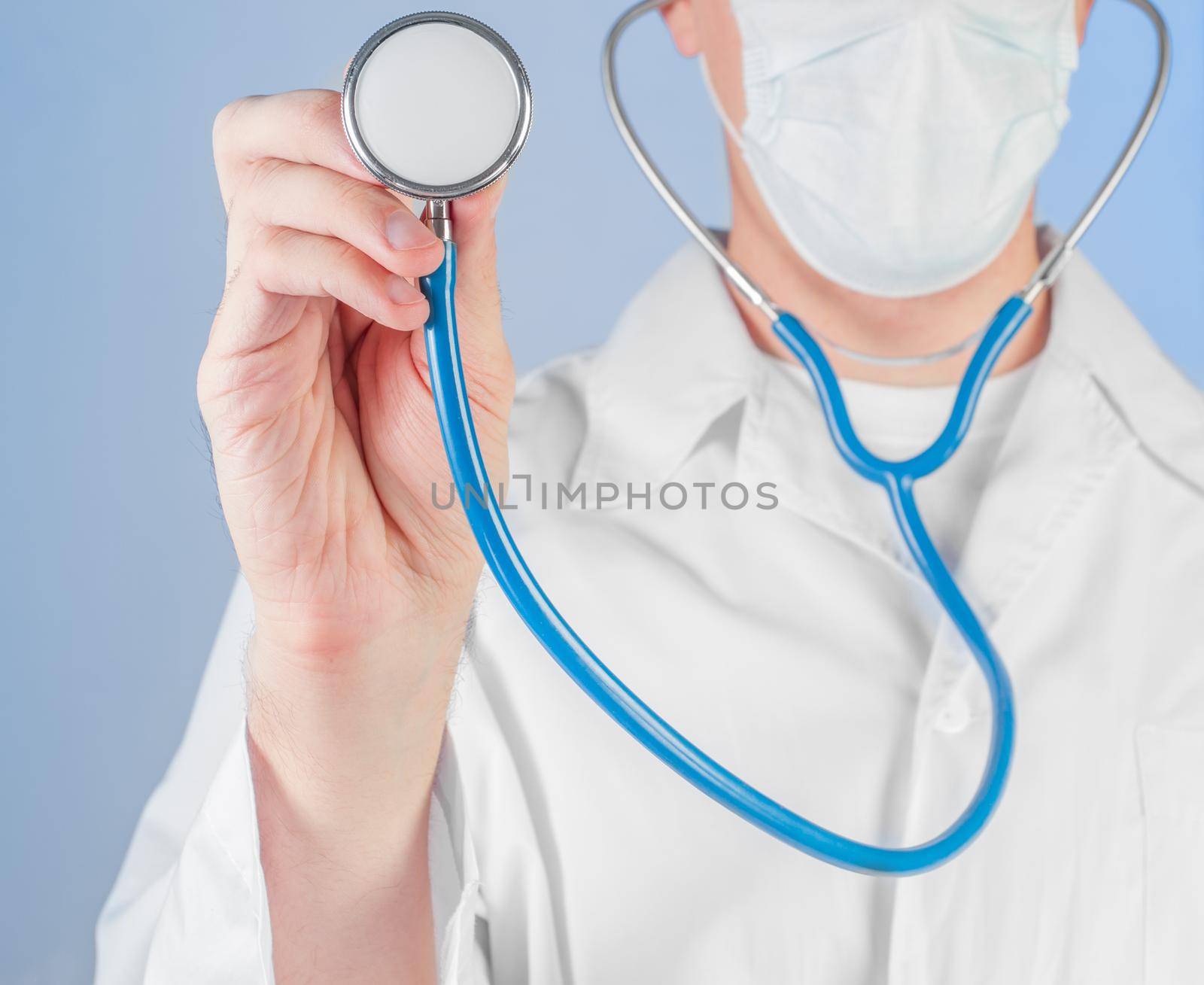 Male doctor listens to a stethoscope, close-up