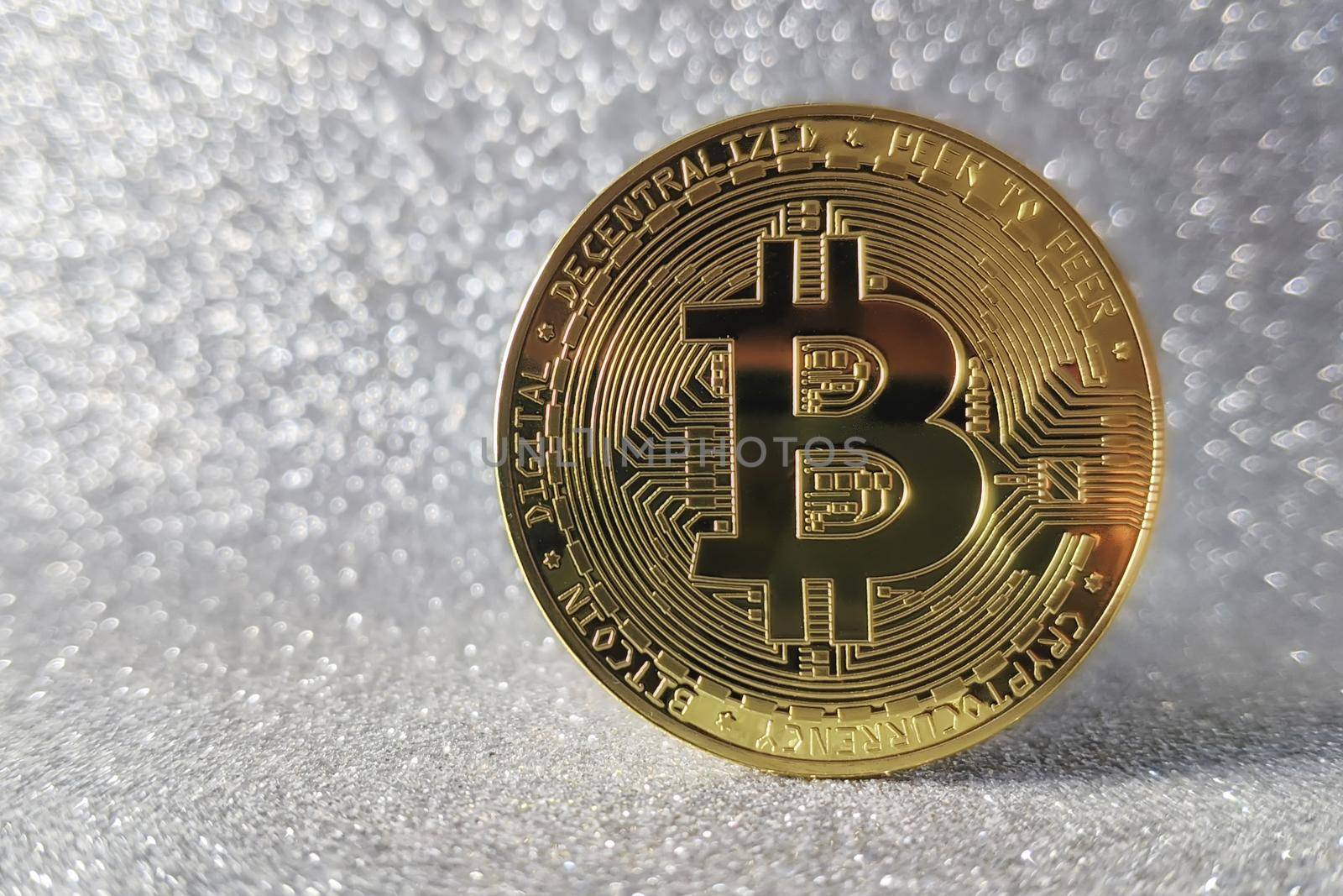 Bitcoin gold coin and defocused glitter background by Maximusnd