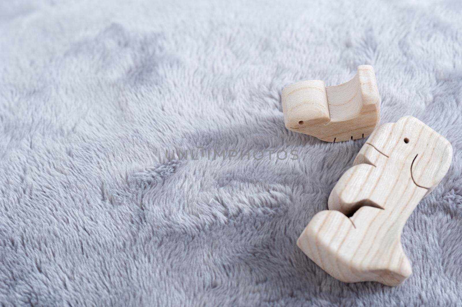 cute wooden toy animals on fluffy fabric