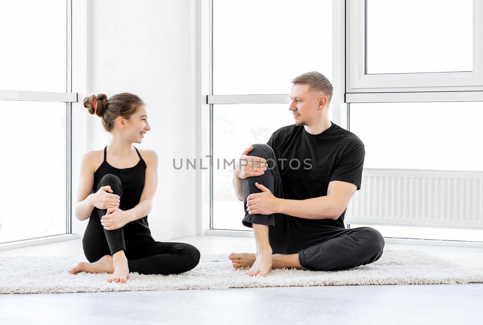 Father with daughter doing fitness exercises by tan4ikk1