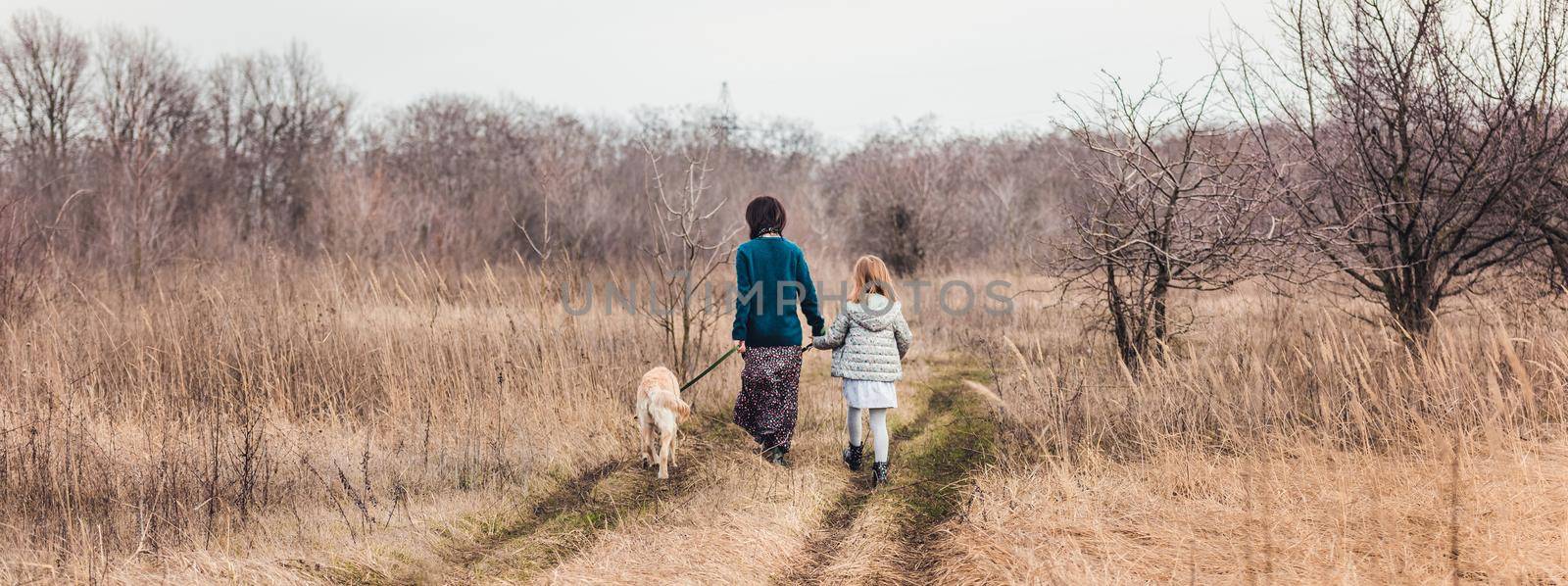 Mother and daughter walking dog by tan4ikk1