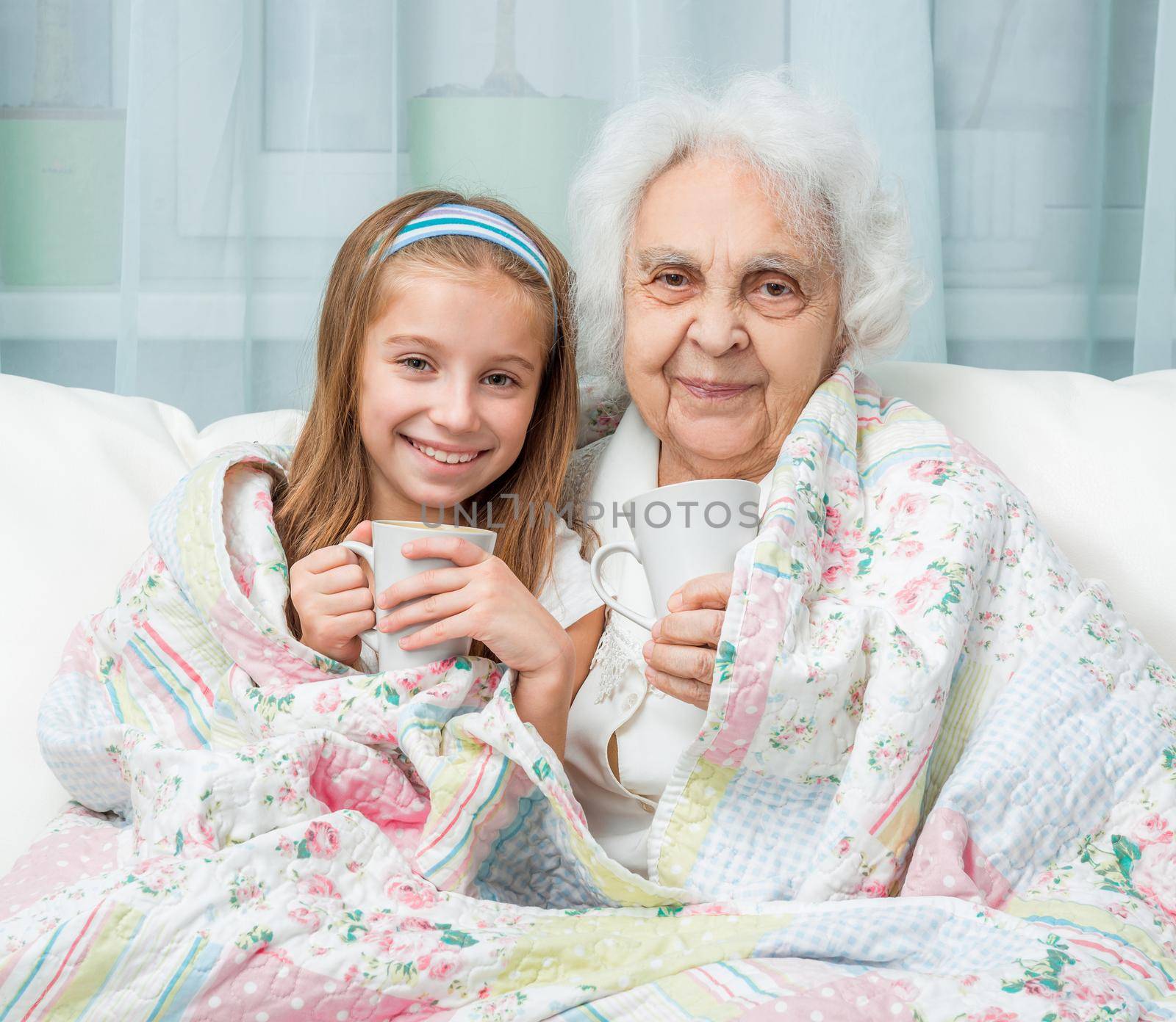 grandmother and granddaughter drink tea by tan4ikk1