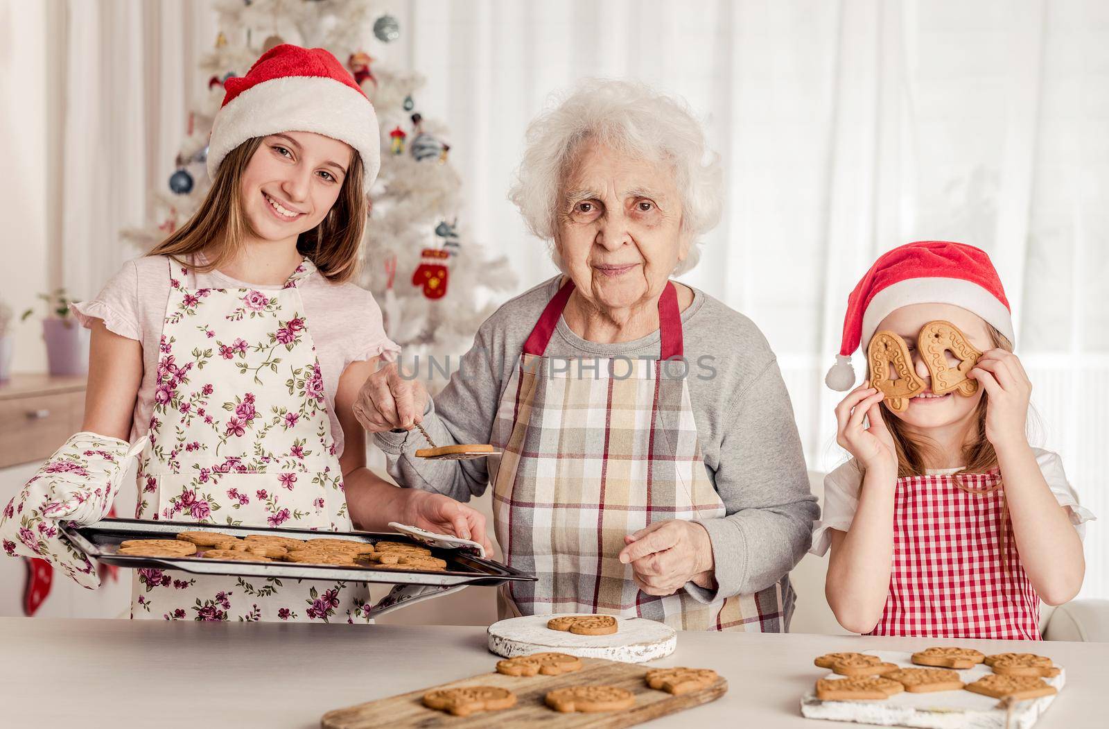 Grandmother with granddaughters baking cookies by tan4ikk1